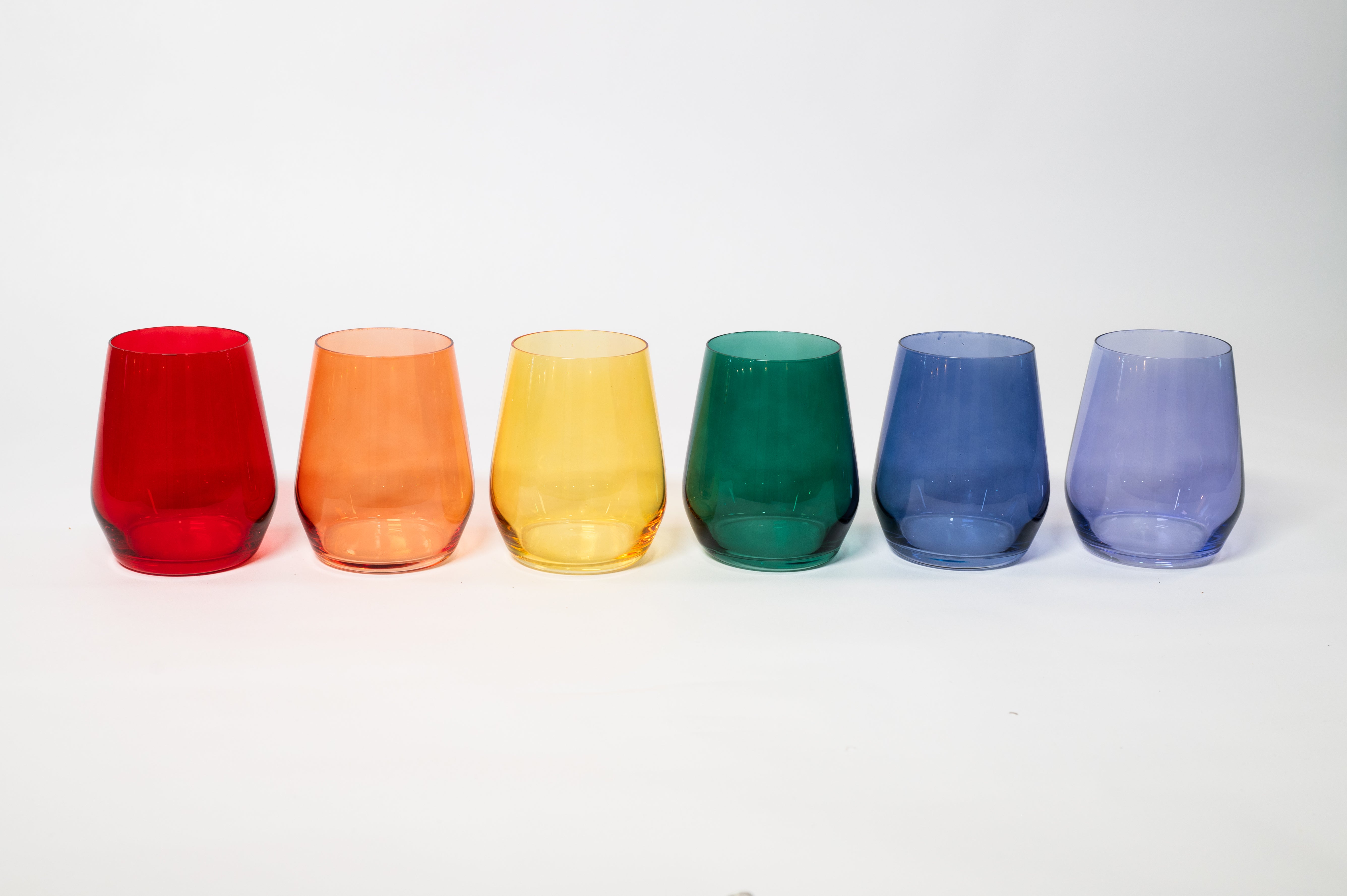 Stemmed Rainbow - Bold Babes wine glasses with vibrant colorful hues arranged on a surface