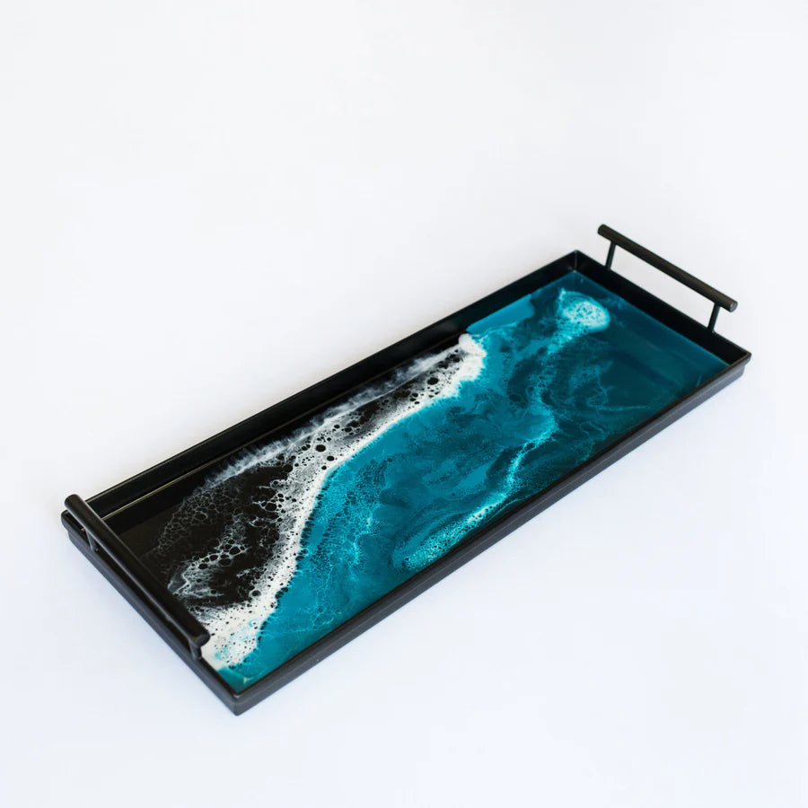 Decorative resin tray with blue and black design on a white background