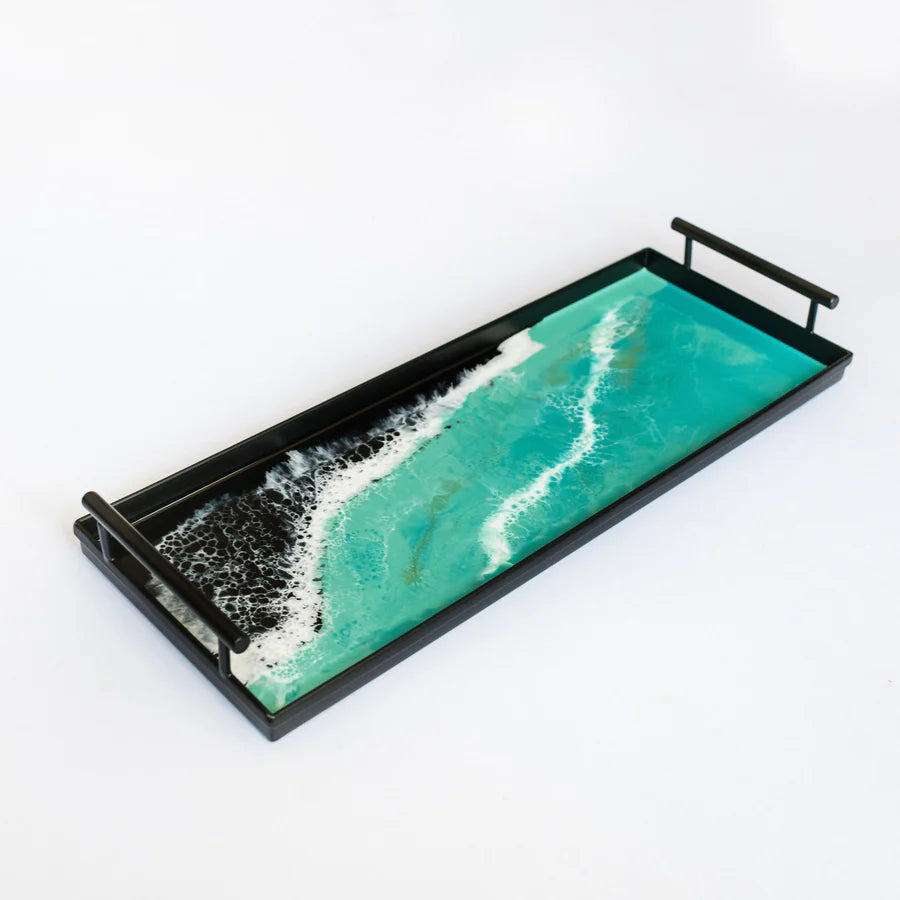 Decorative resin tray with ocean wave design on a white background