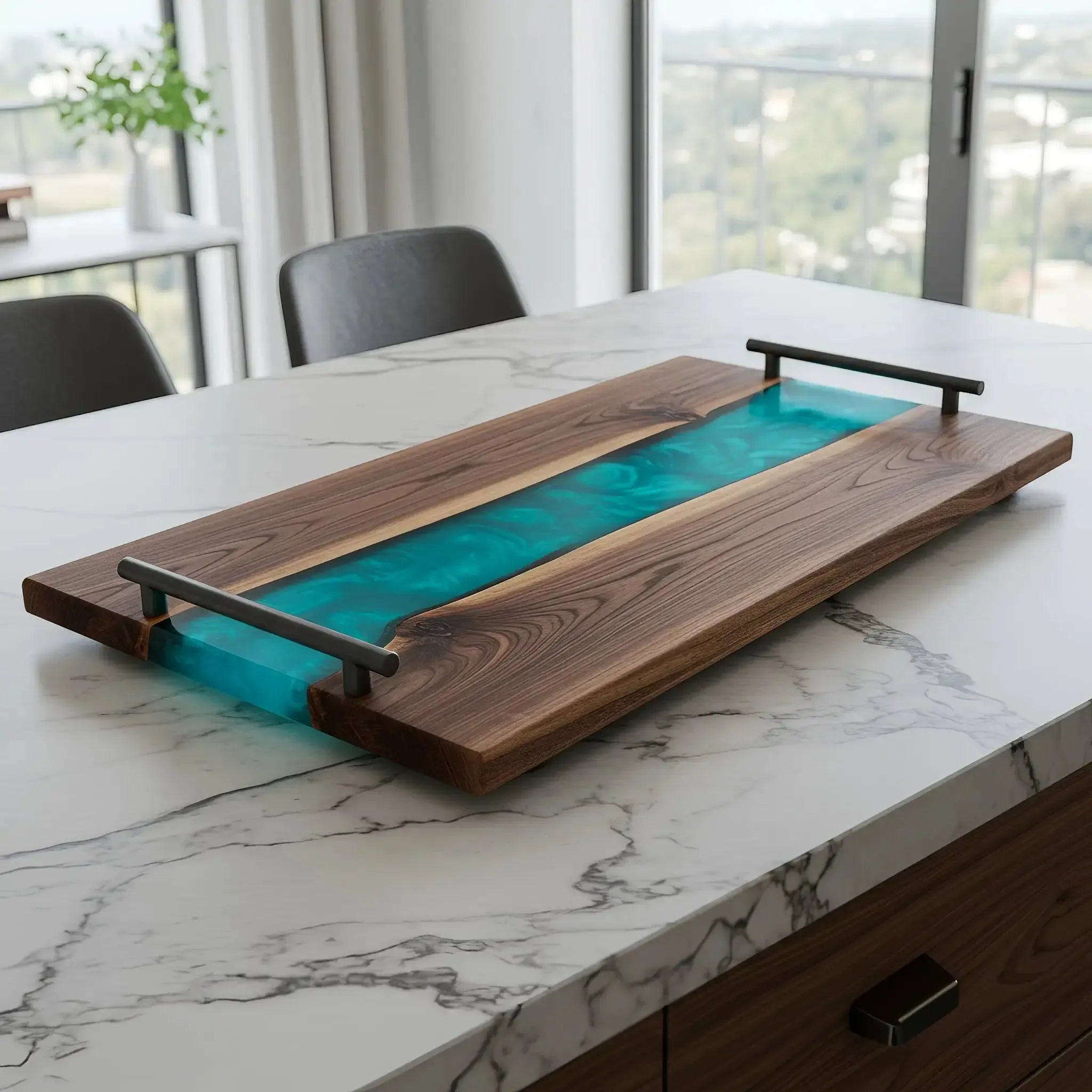 charcuterie board, 18 inches by 9 inches, made from live edge black walnut wood with a deep teal blue epoxy river flowing through the center. The resin has a rich, ocean-inspired tone—between deep teal and sapphire—with soft swirls and a smooth, glossy finish. Matte black metal handles are attached at each end.