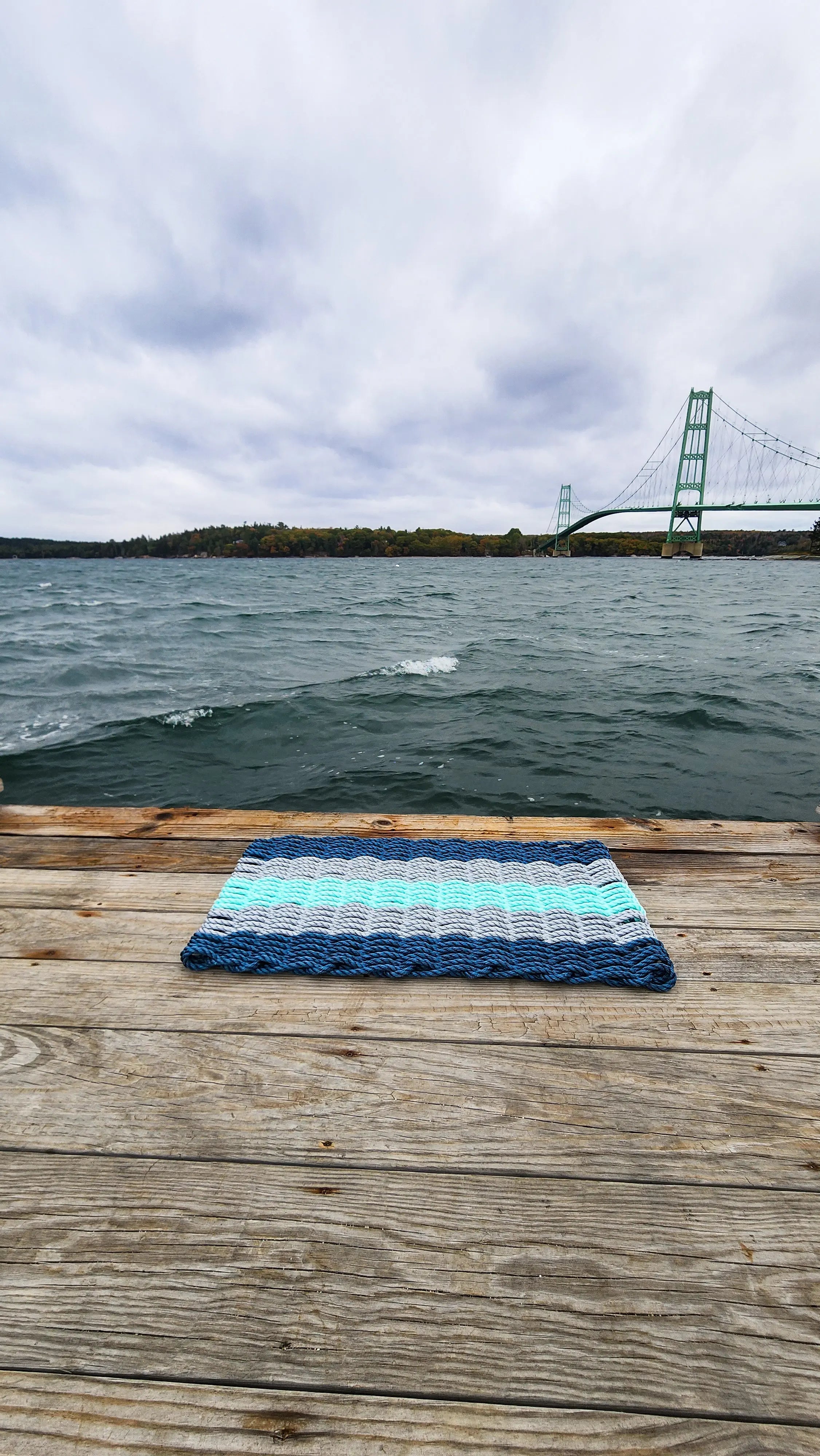 Five Stripe Rope Mat made with Lobster Rope in navy, light gray, and seafoam colors