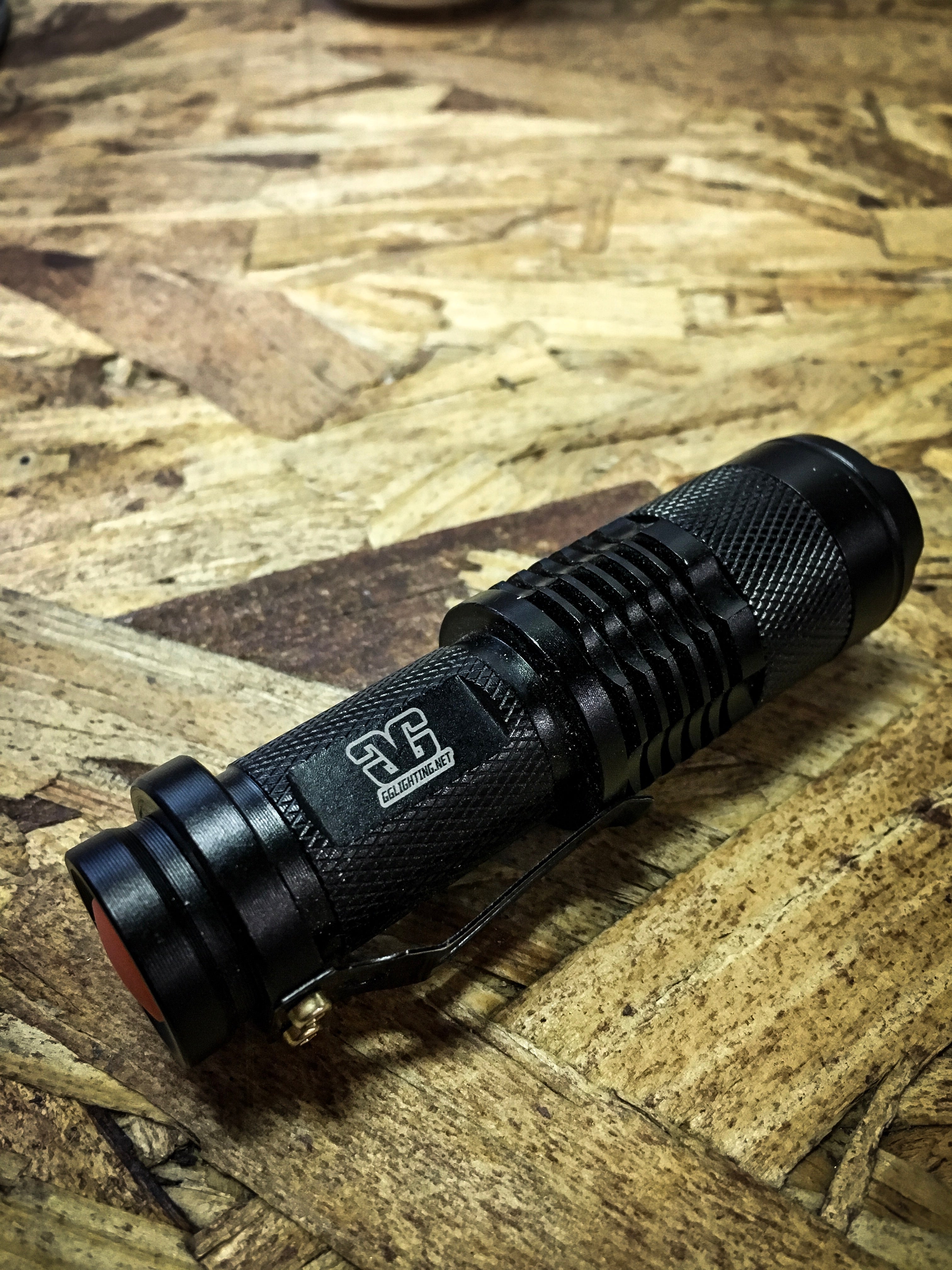 Three Function Rechargeable Flashlight by GGLighting showing black flashlight with wrist strap