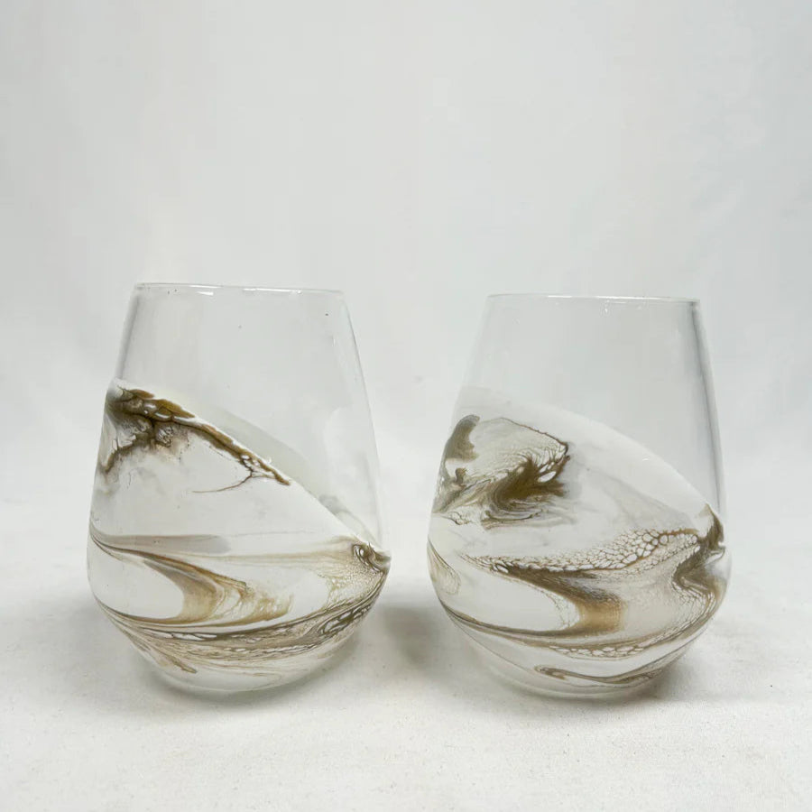 Two resin wine glasses with marbled design on a white background