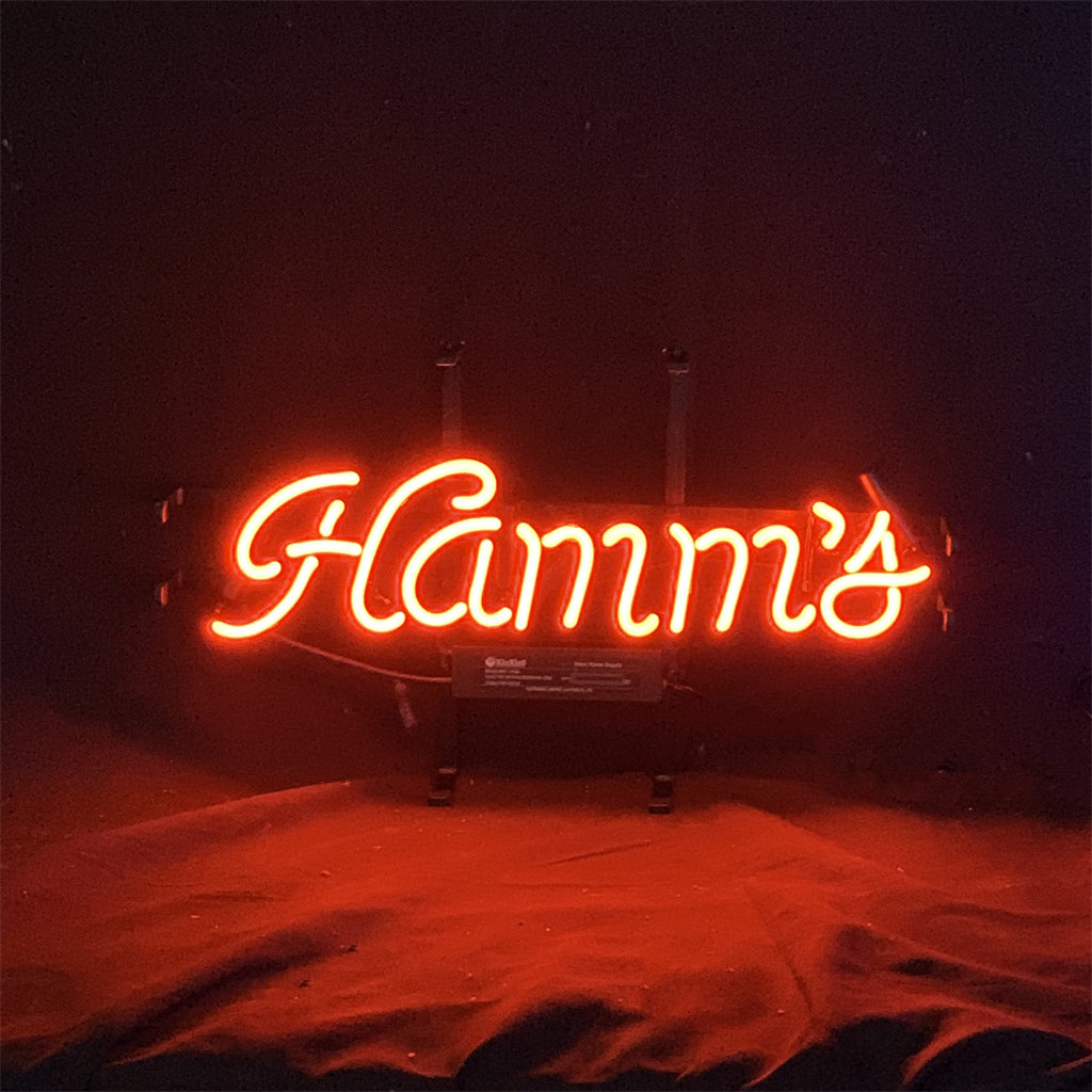 Red Hamm's Beer Neon Sign Light glowing in red with metal grid backing