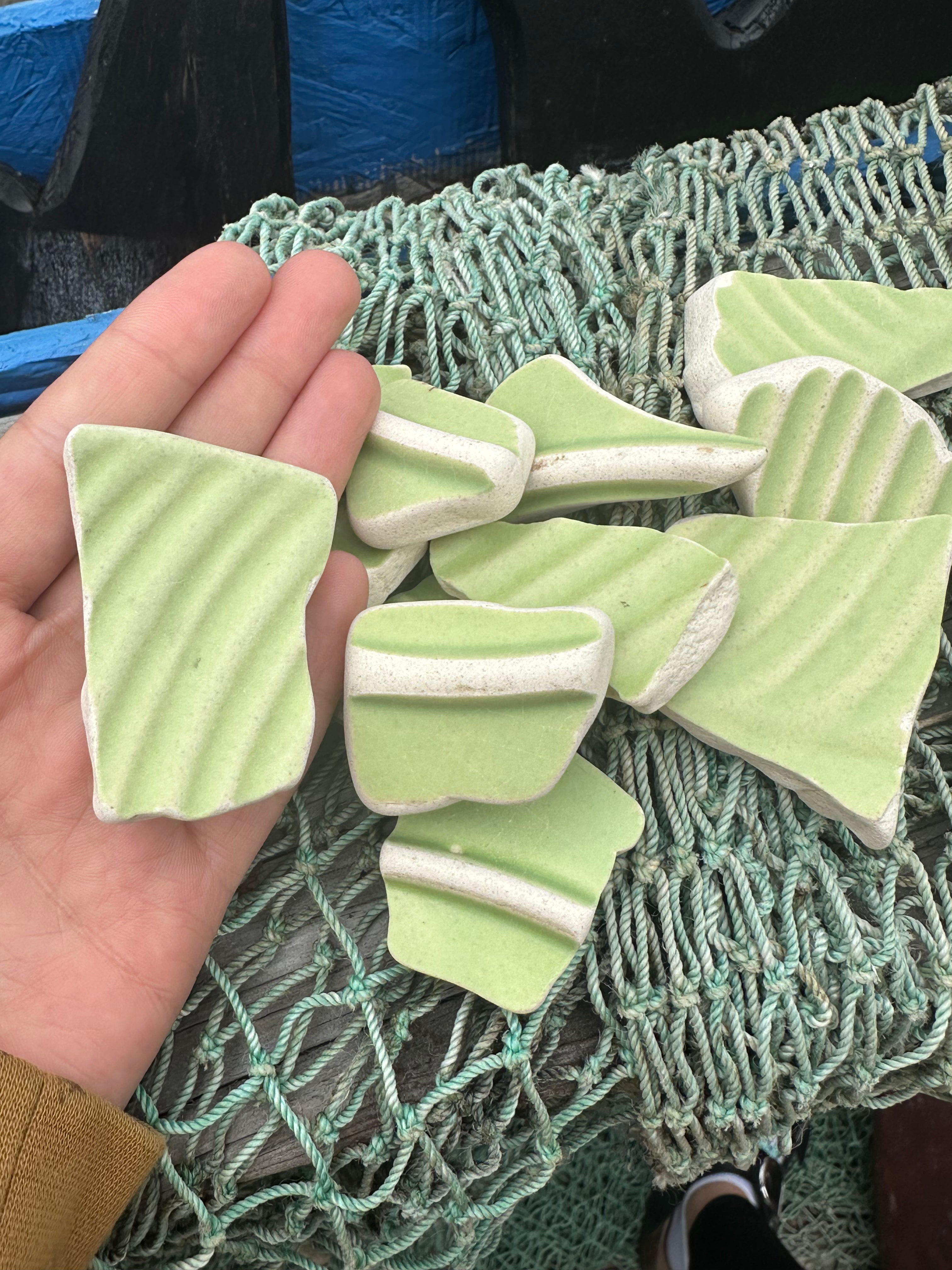Assorted hand-tumbled pottery pieces in earthy colors for mosaic crafts