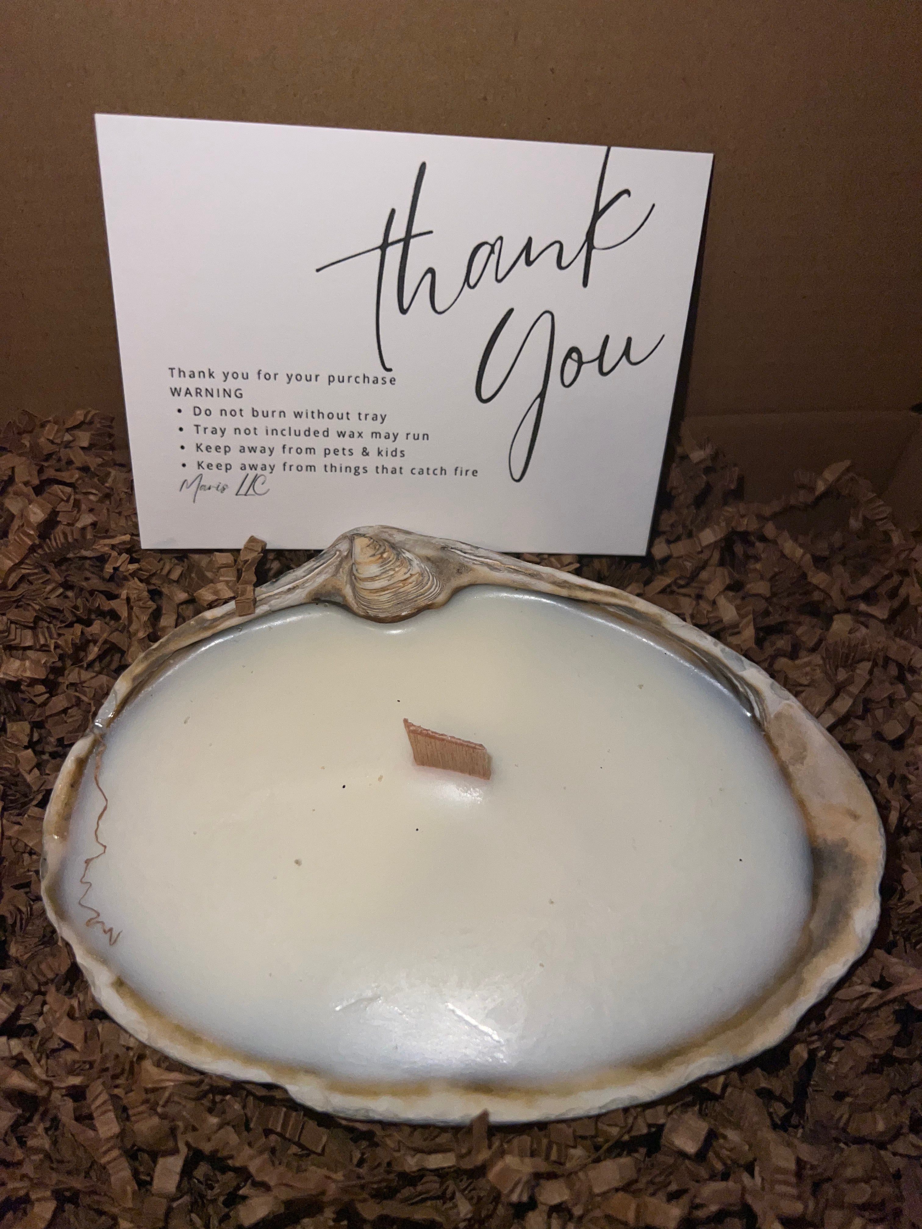 Limited edition candle in a dark, weathered quahog shell from December 2025 storm