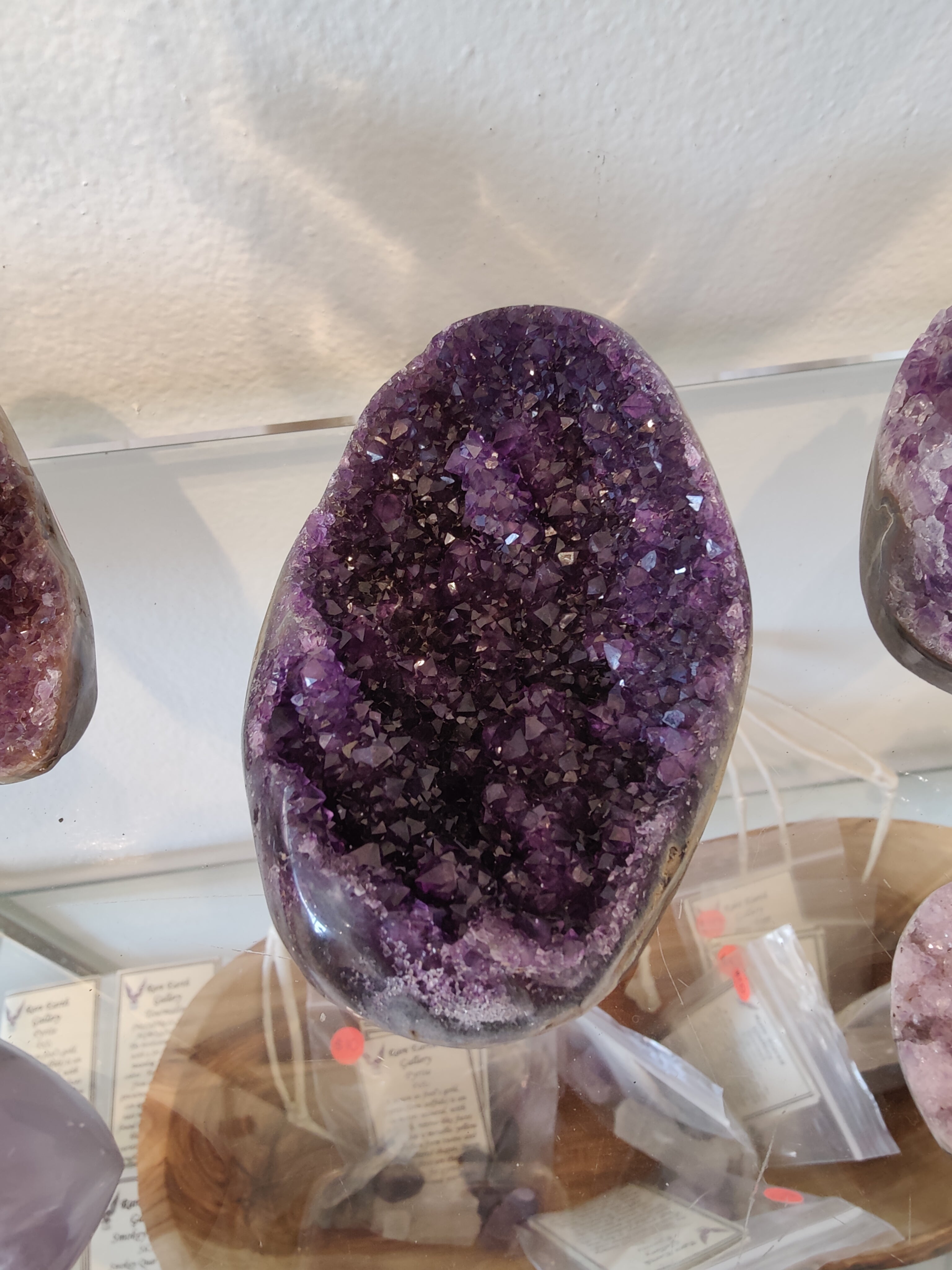 Polished Amethyst Geode Sculpture with purple crystalline center and smooth outer edge