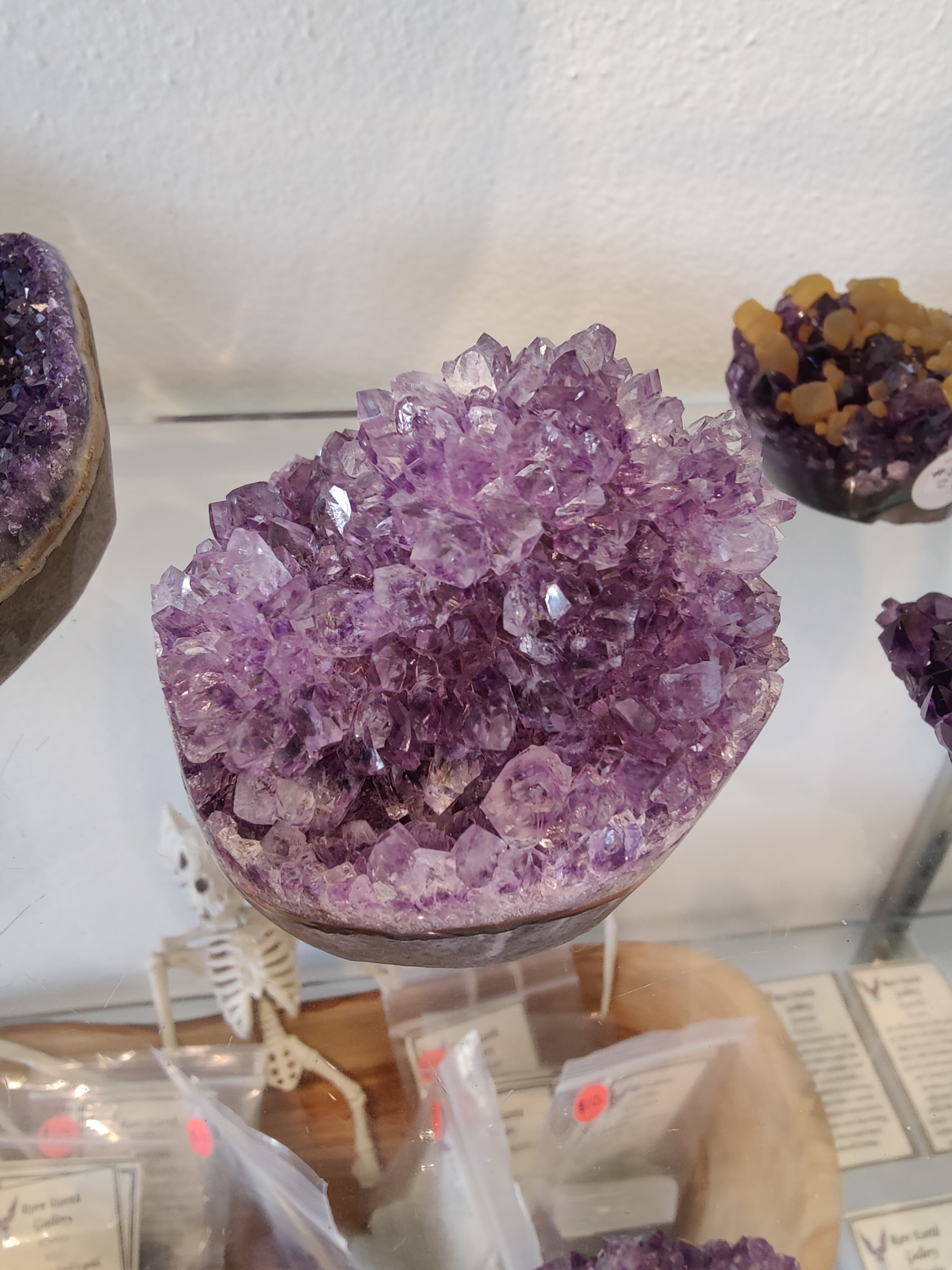 Polished amethyst geode sculpture shaped like a flower with deep purple crystals from Brazil