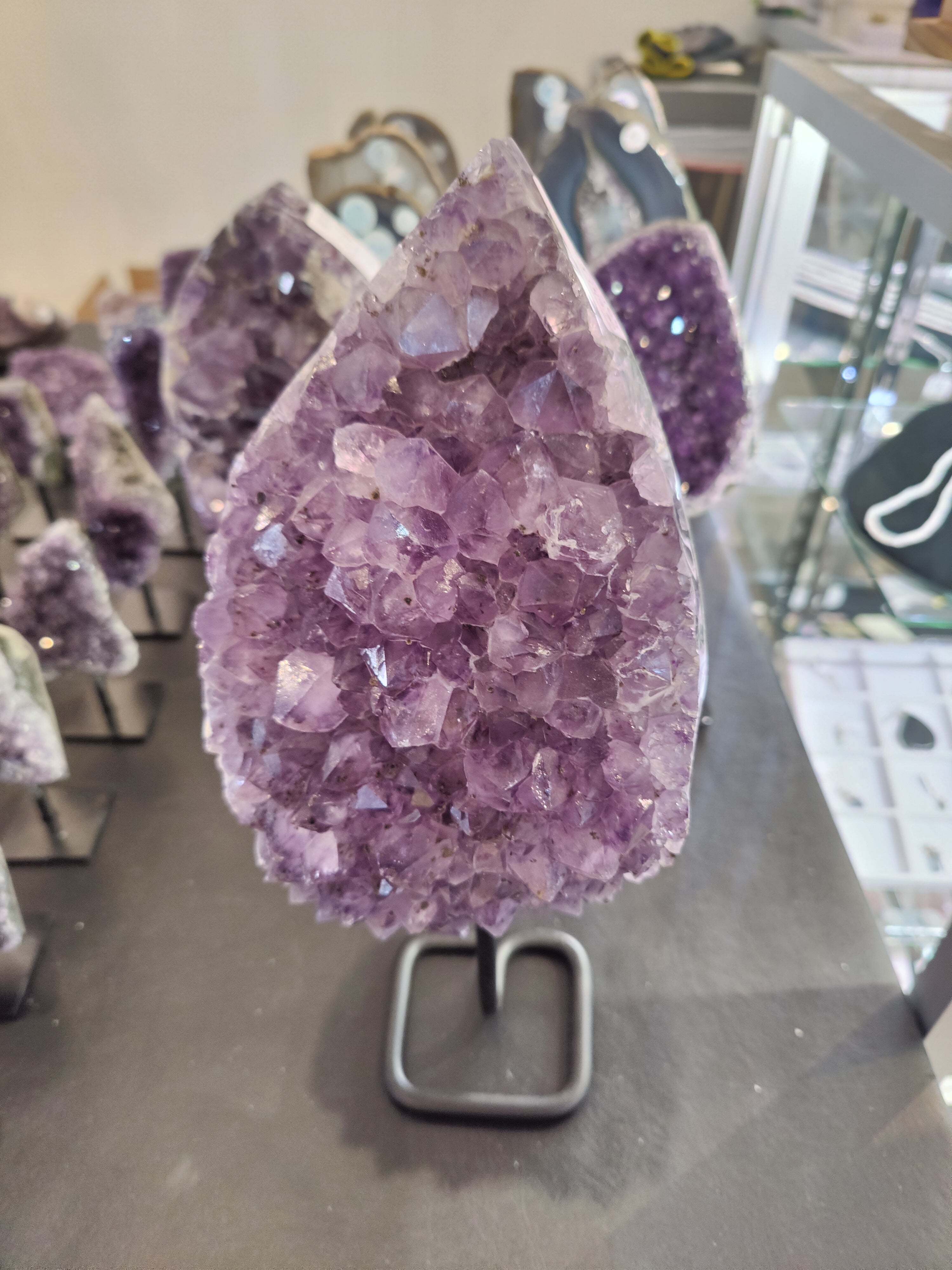 Amethyst Crystal Geode mounted on a metal stand, shown upright