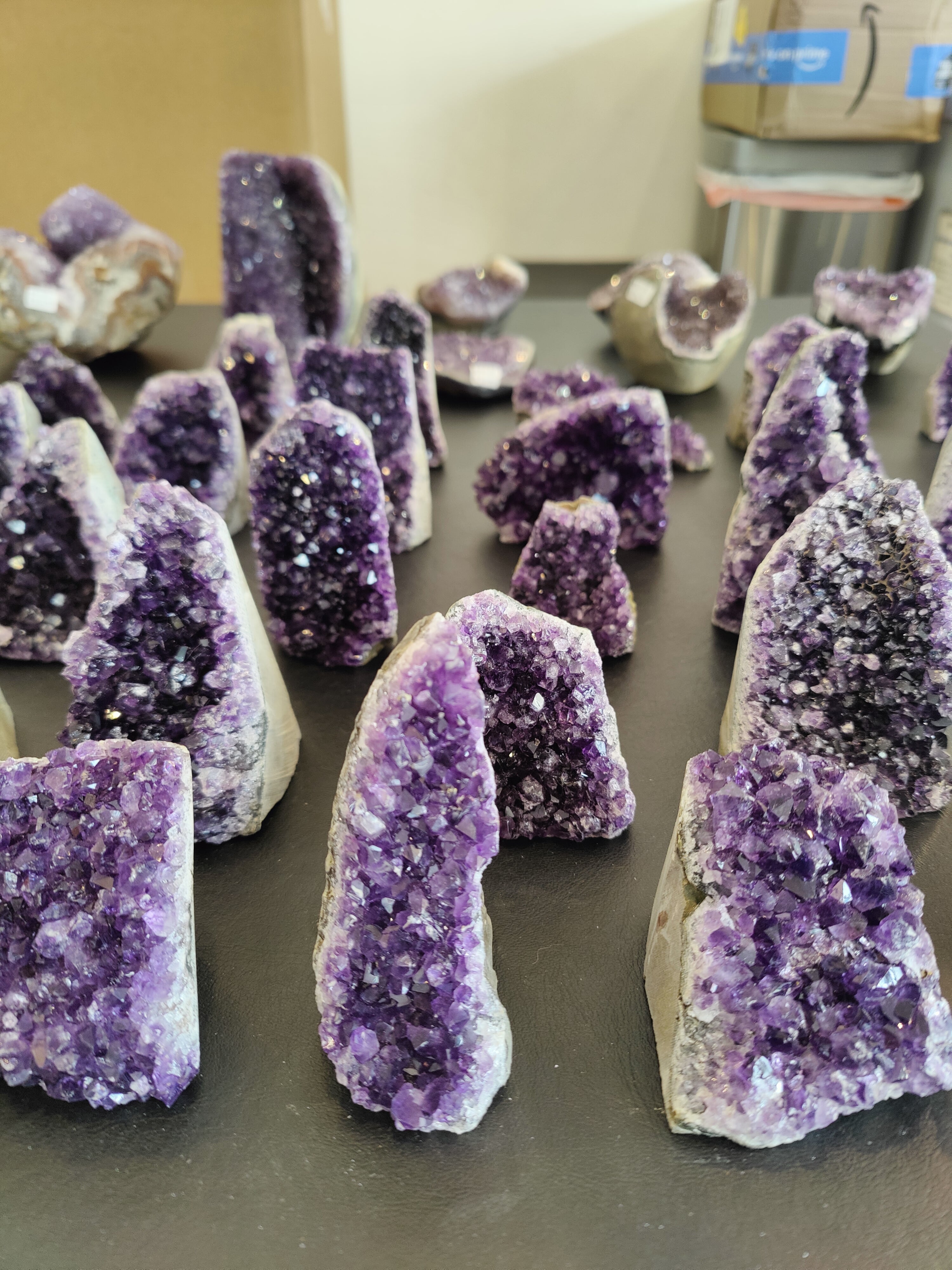 Deep purple amethyst cut base geode with crystalline interior against a neutral background