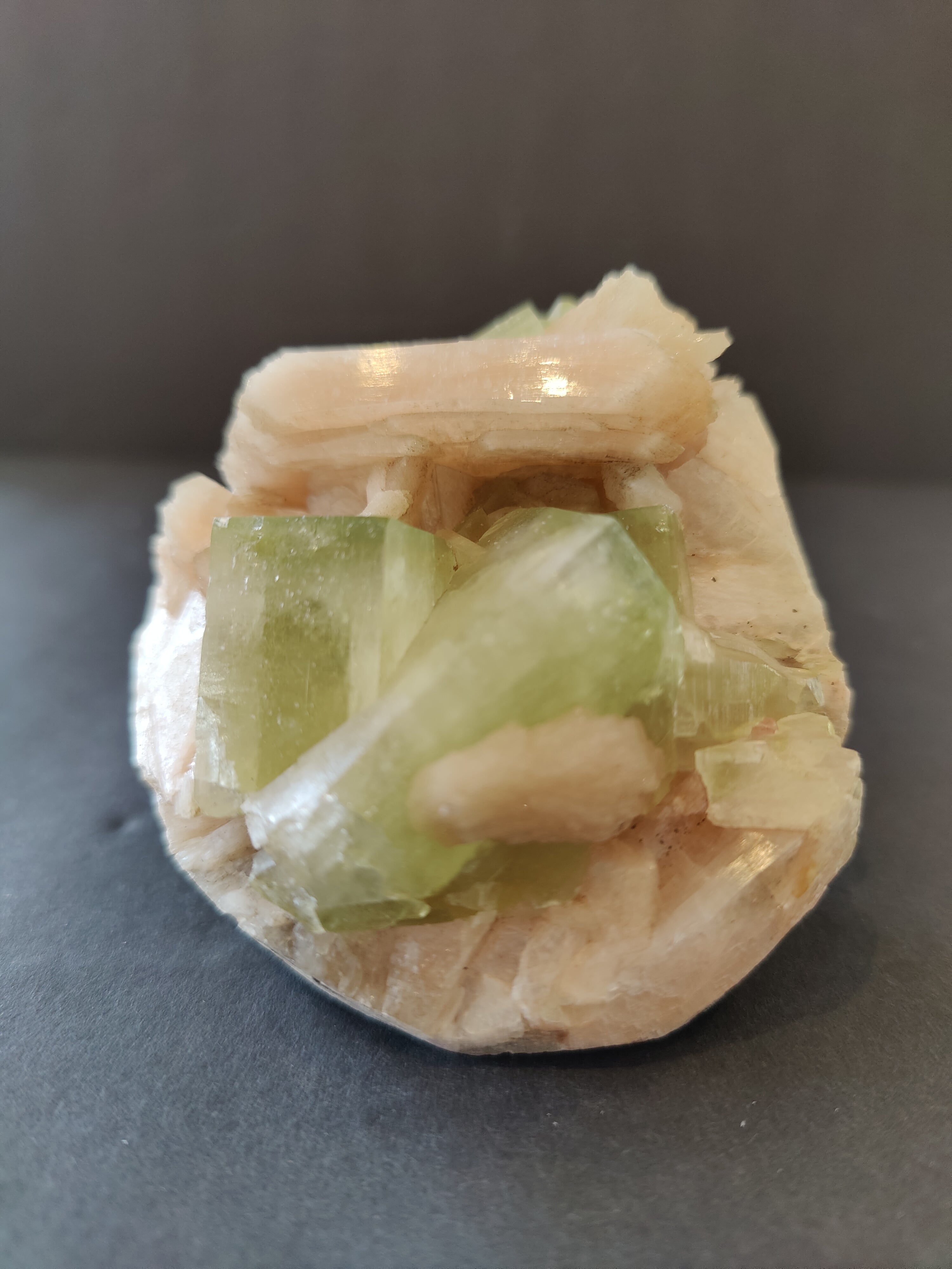 Green Apophyllite cubes with peach Stilbite specimen on matrix, showing cubic crystal formations