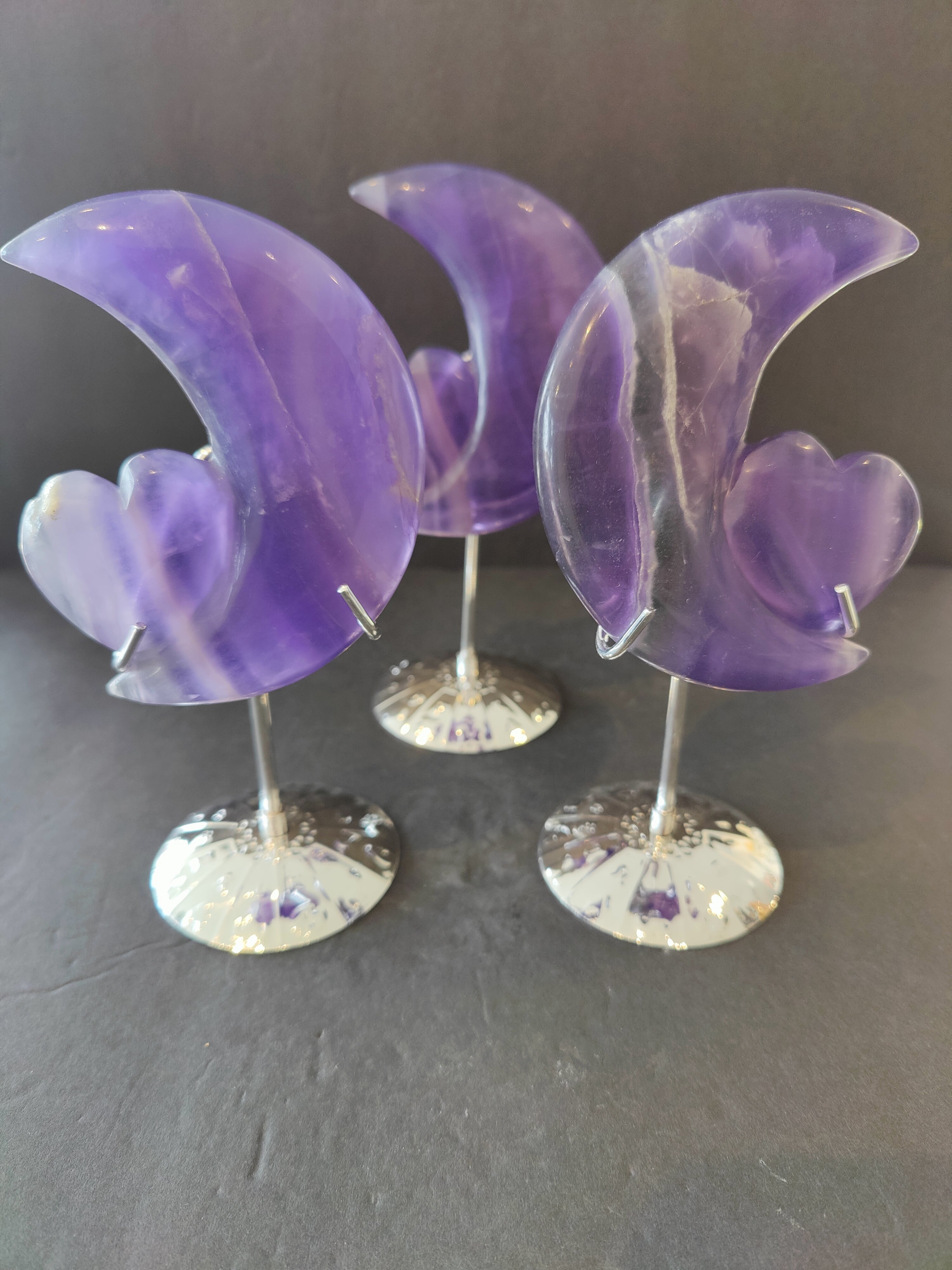 Purple fluorite half-moon and heart sculpture mounted on a 5 inch metal stand