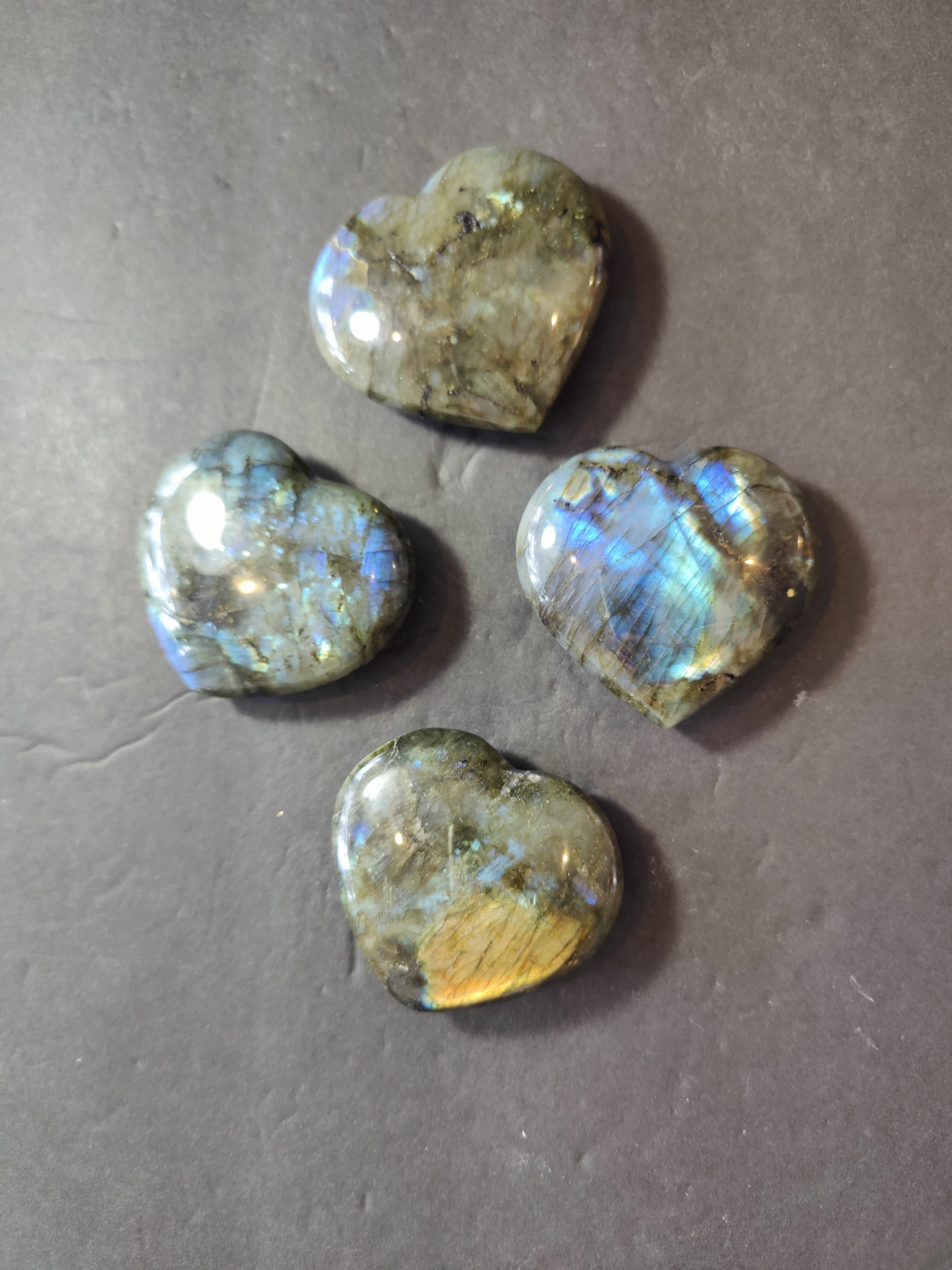 Labradorite carved and polished heart sculpture showing natural stone texture and colors