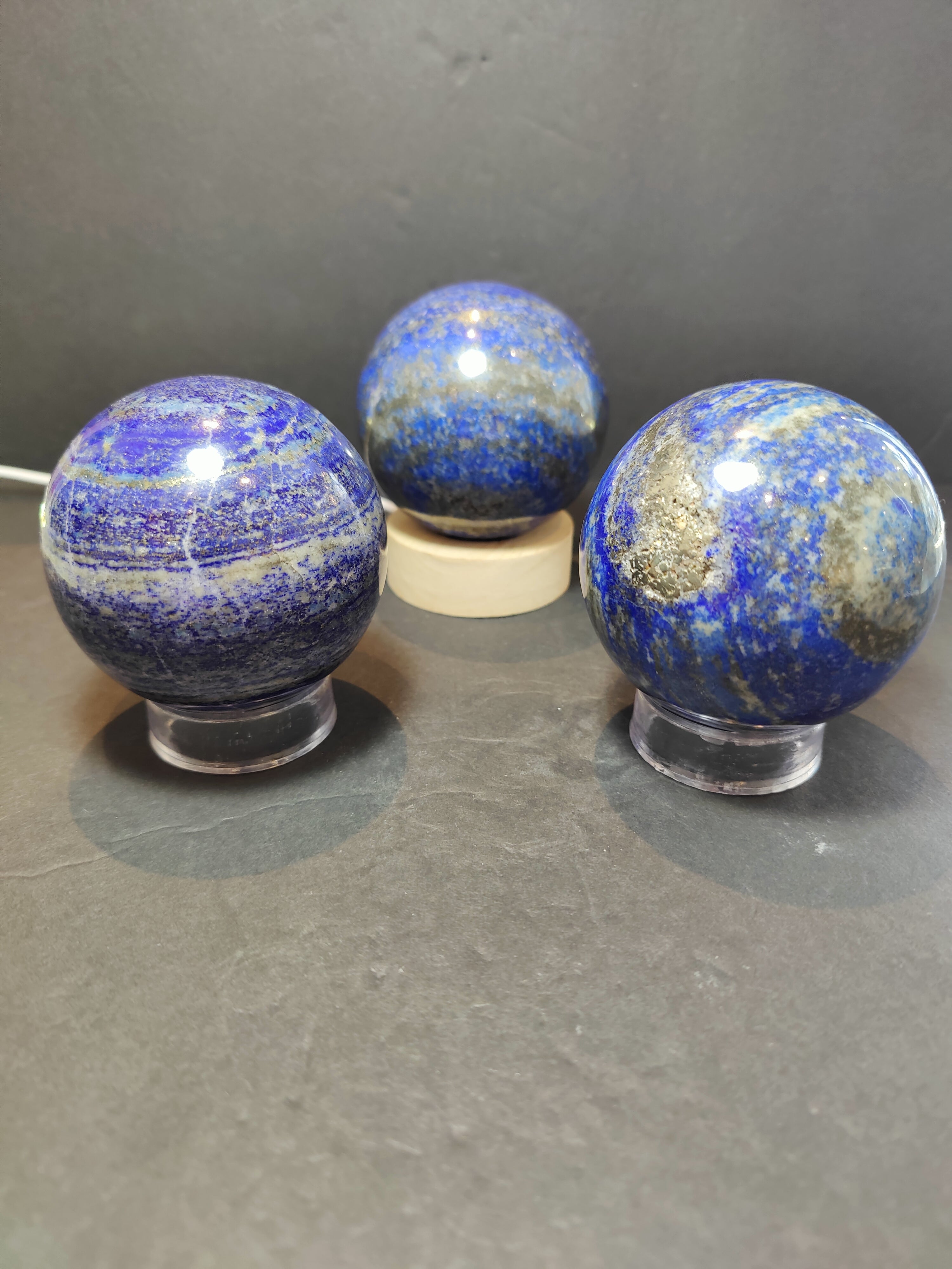 Lapis Lazuli Polished Sphere Sculpture displaying deep blue stone with gold flecks on a white background