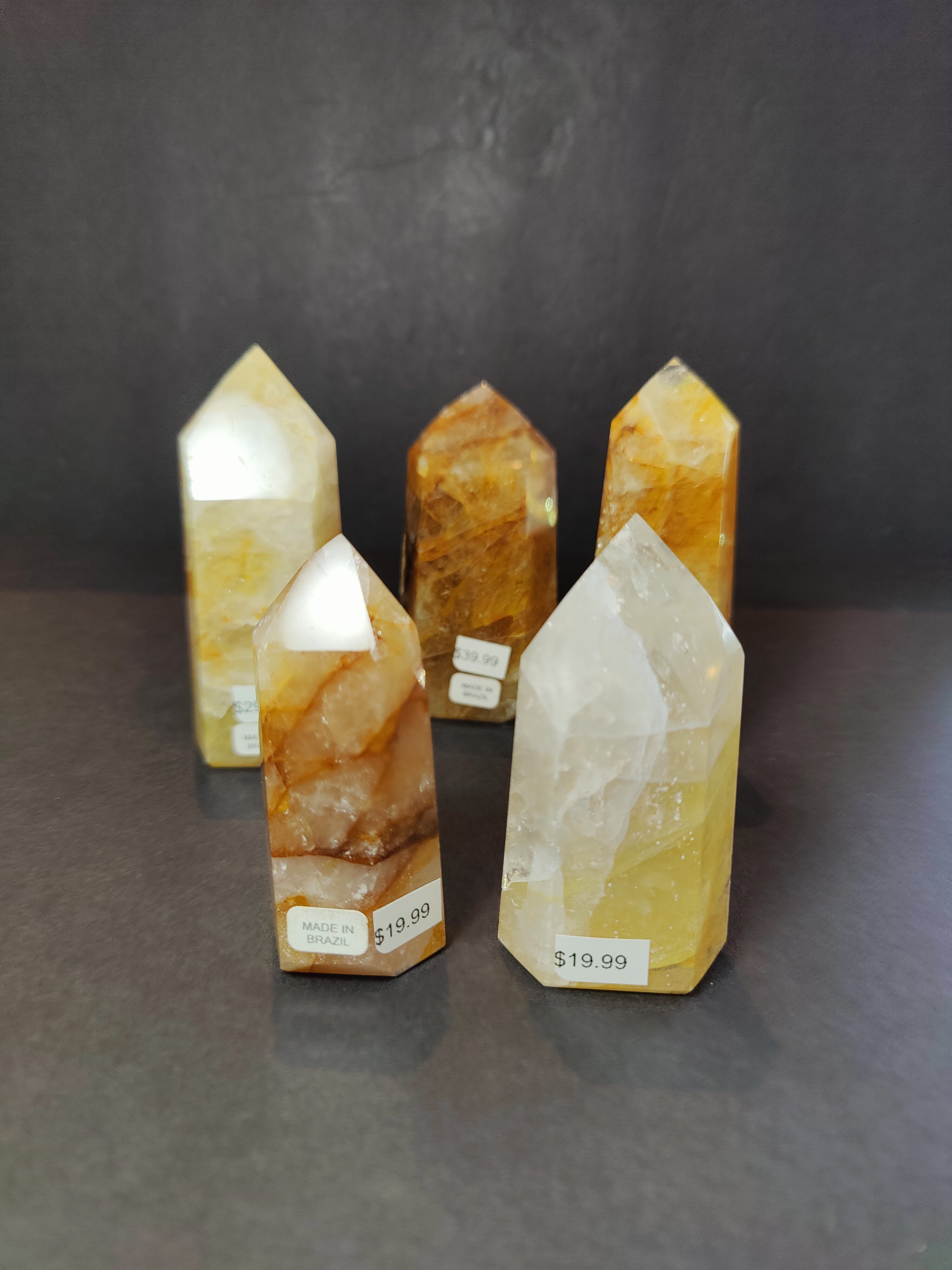 Polished Golden Healer Hematoid Quartz Obelisk Tower Sculpture upright on white surface