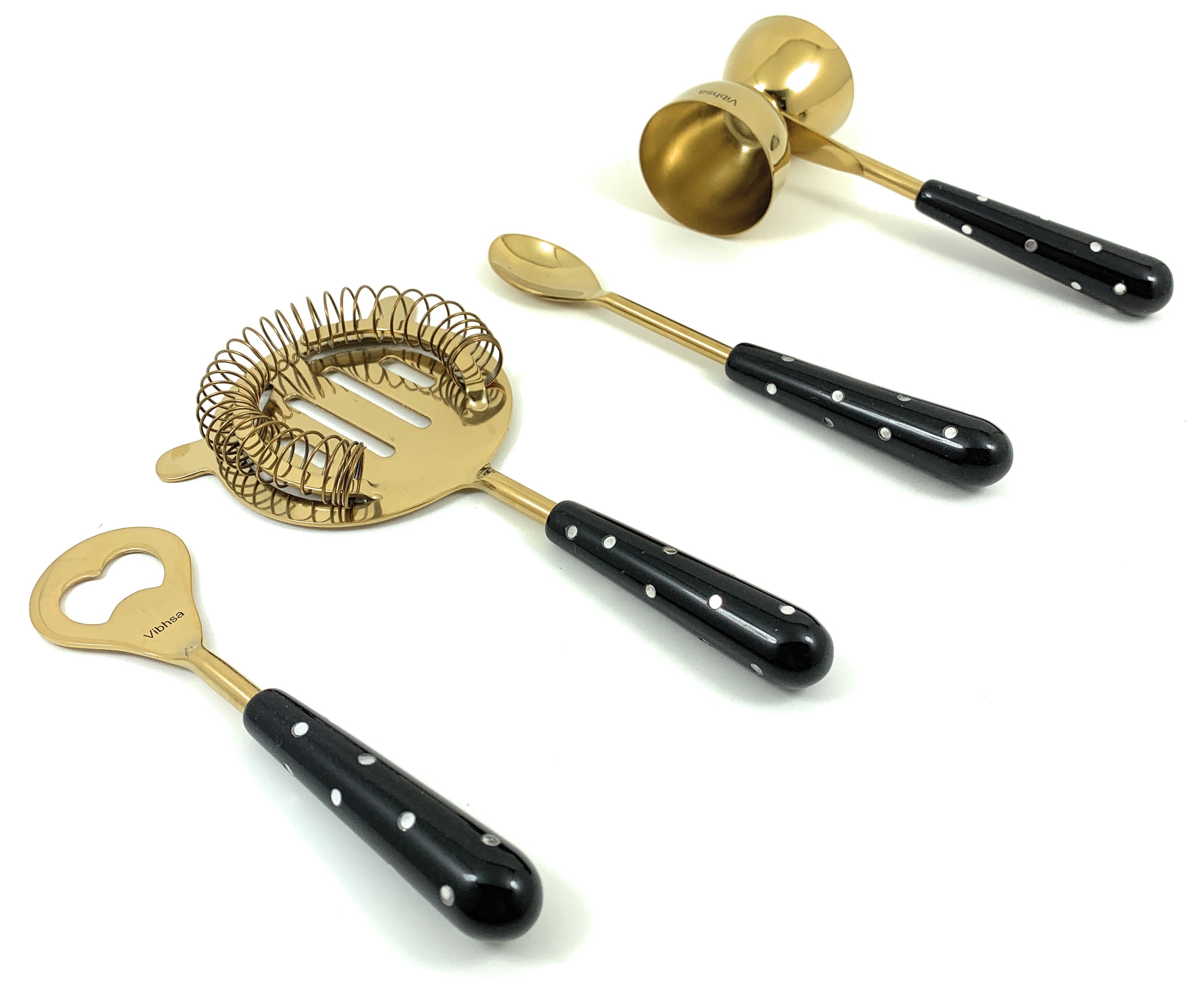Vibhsa golden black bar tools set of 4 including flat opener, jigger, stirring spoon, and martini shaker on wooden surface