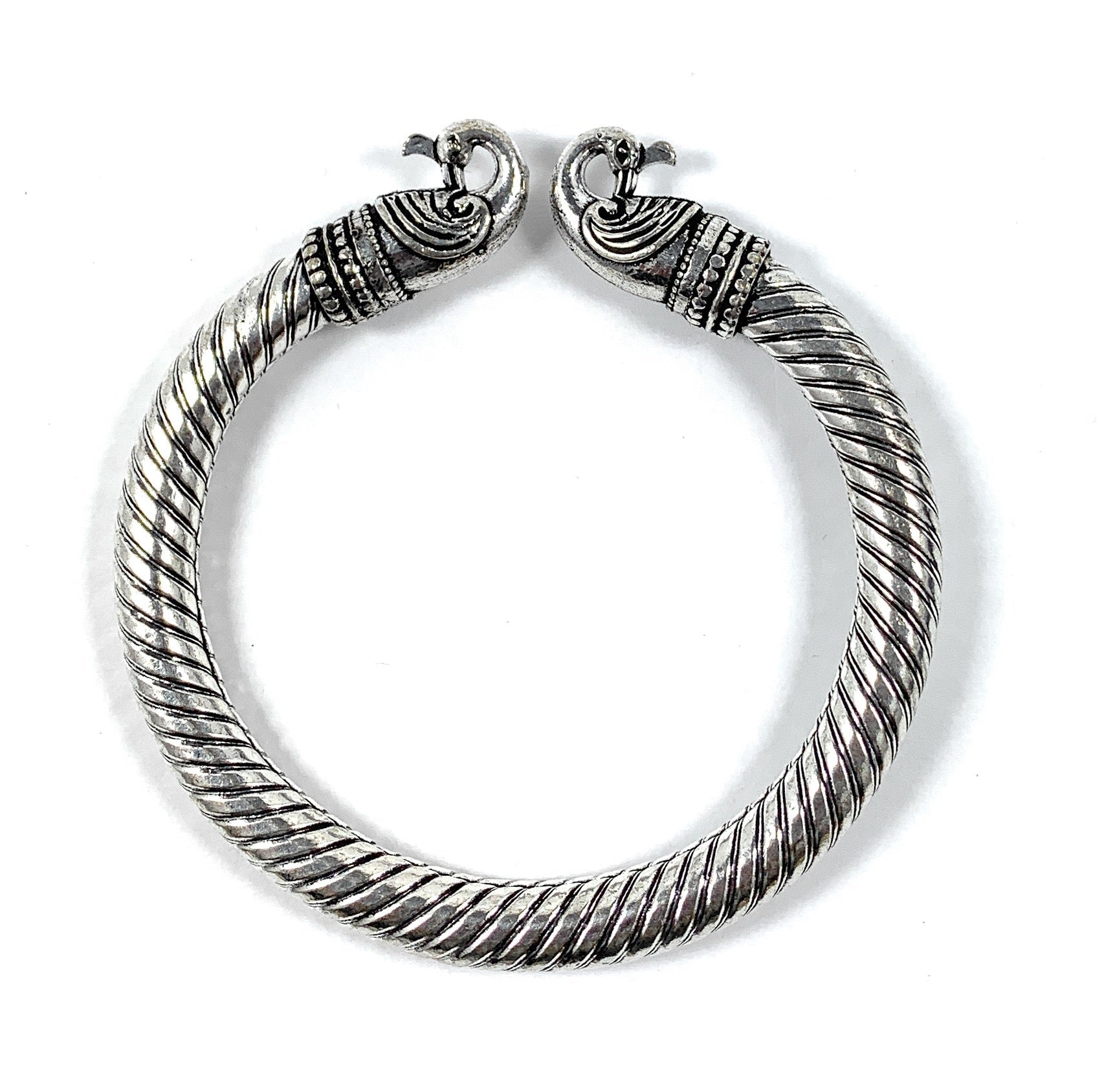 Antique Norse Peacock Head Viking Bracelet featuring two peacock heads twisted together in bronze tone, shown on a white background.