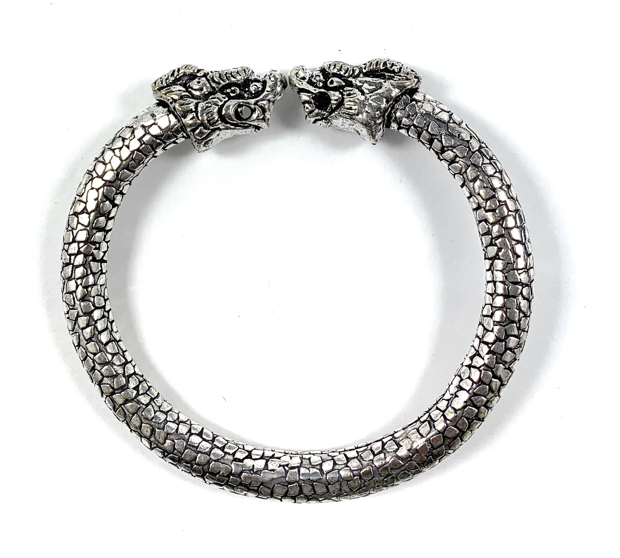 Antique Norse Viking Bracelet showing two lion heads and snake pattern on a twisted cuff