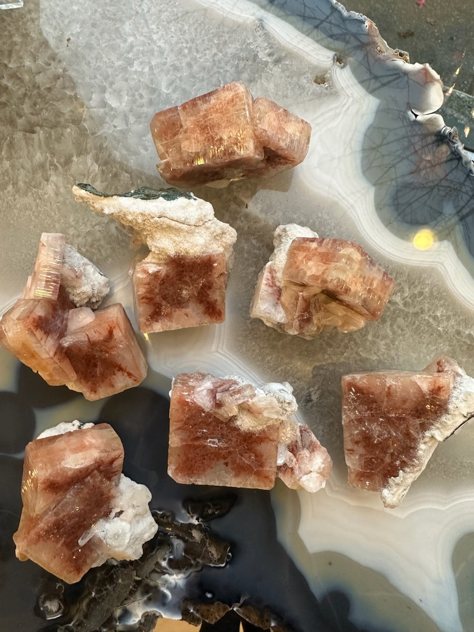 Small Red Apophyllite Cube mineral specimen with Stilbite on white background