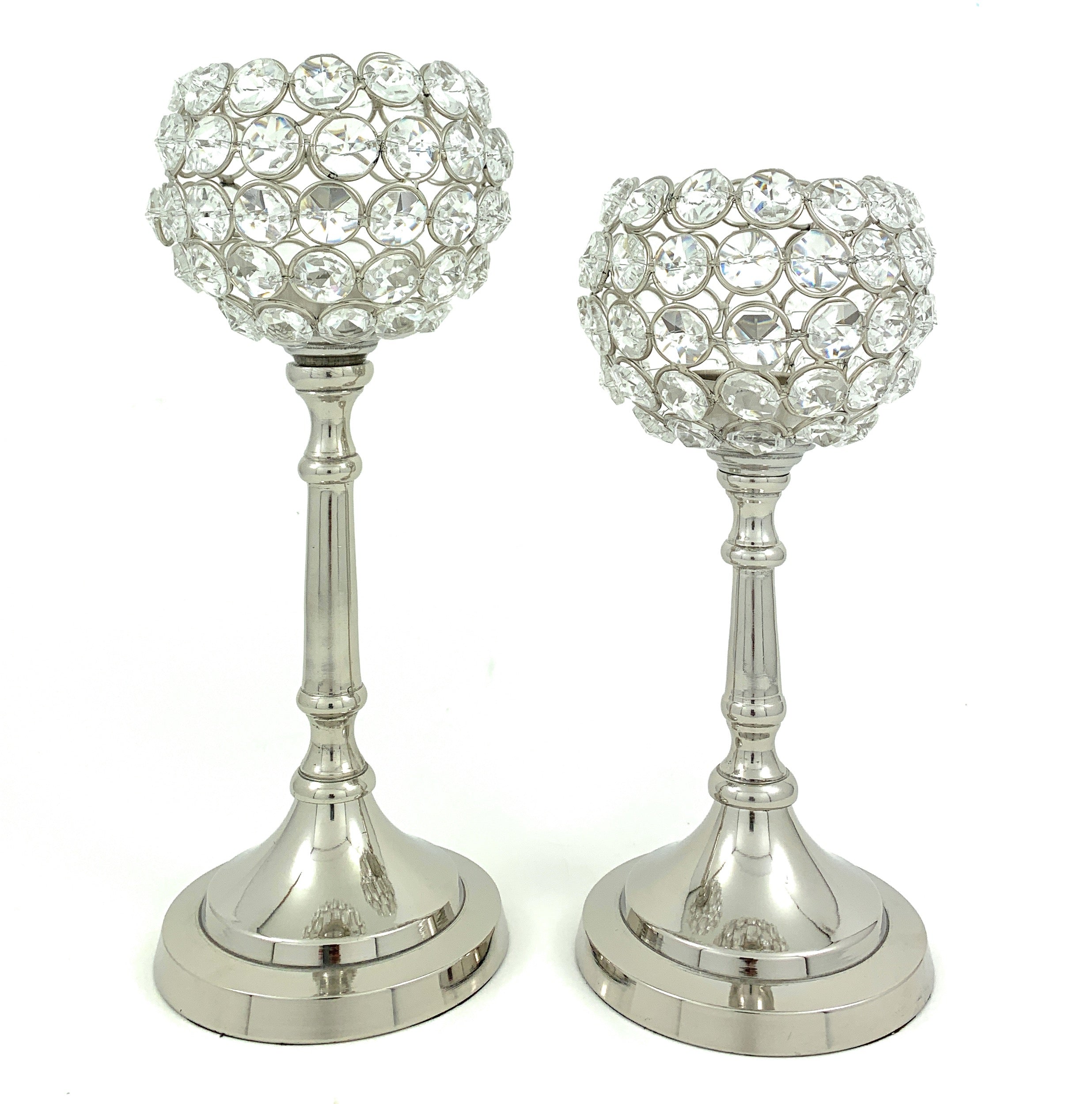 Two Vibhsa round crystal candle holders with aluminum bases and silver finish, shown on a grey textured surface