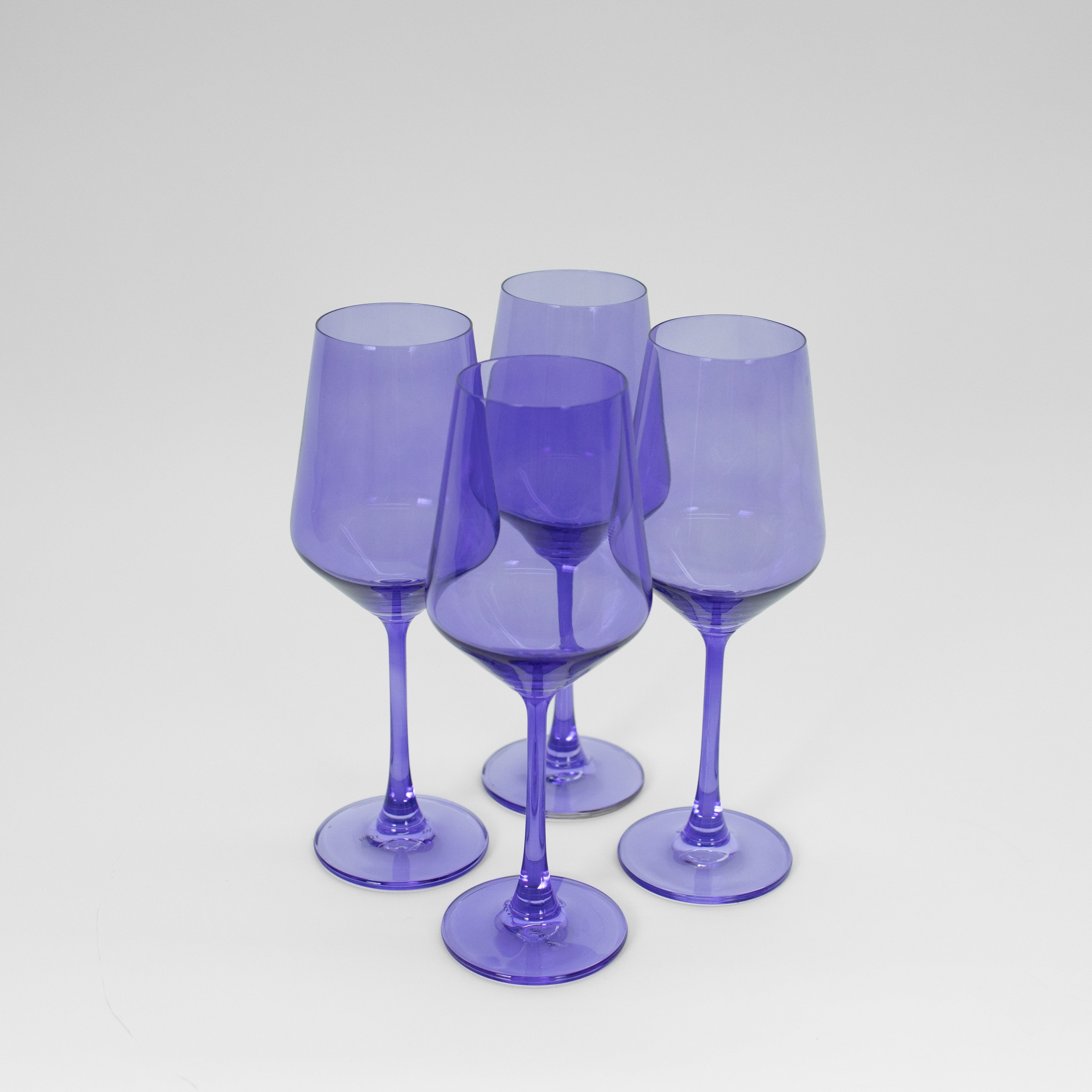 Veri Peri Purple wine glass with a vibrant blue-purple hue on a neutral background