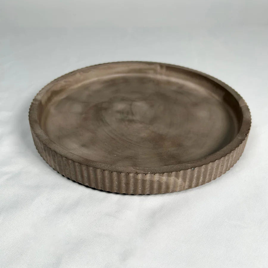 Round brown stone-like resin tray on a white background