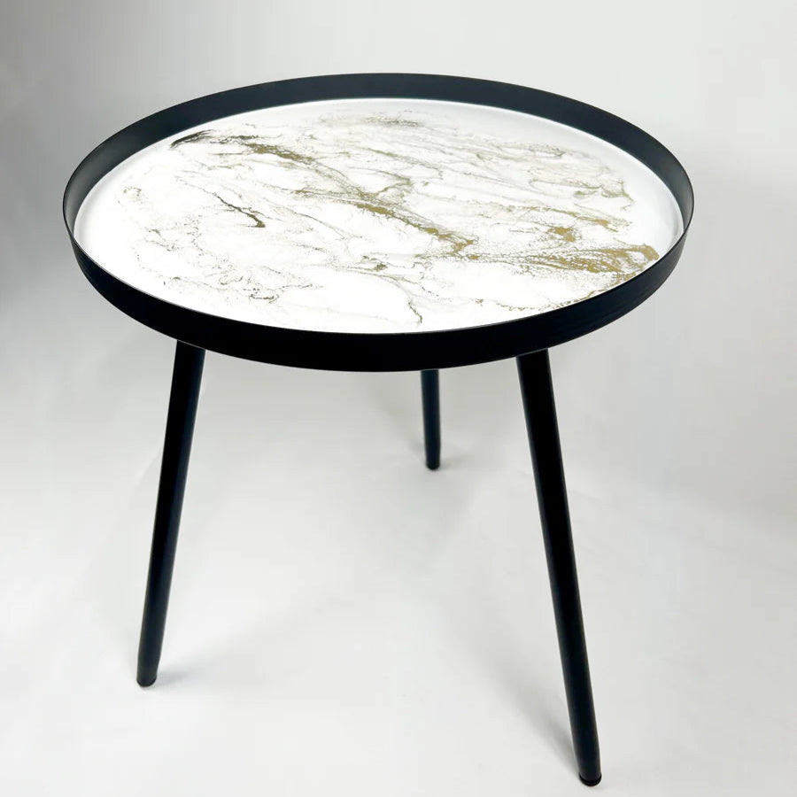 Round resin table with marble-patterned top and black frame on a white background