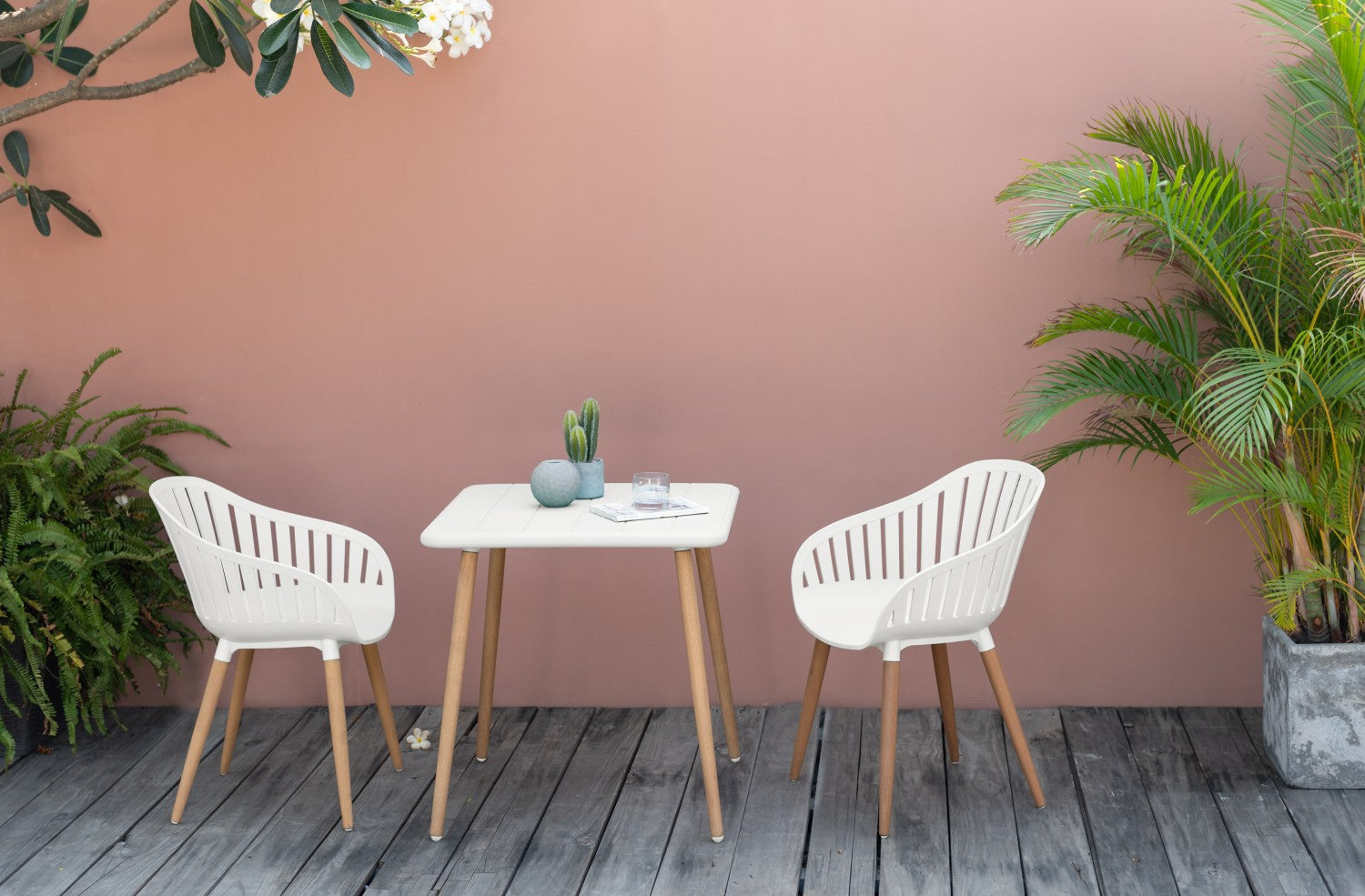 Nassau Square Table – White Social Plastic® with hardwood legs in an outdoor setting.