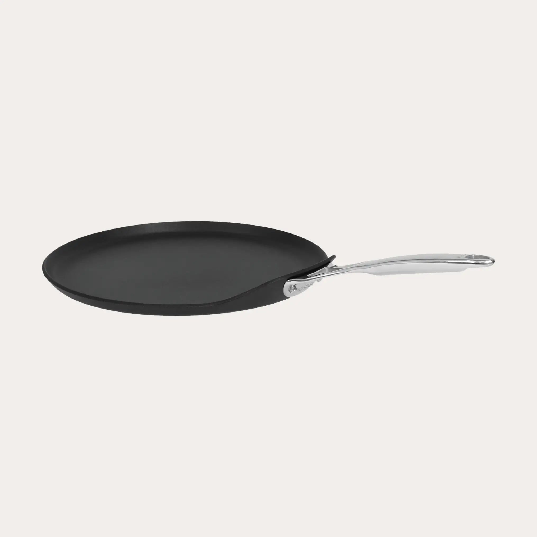 CRISTEL USA Crepe Pan with fixed stainless-steel handle on stovetop