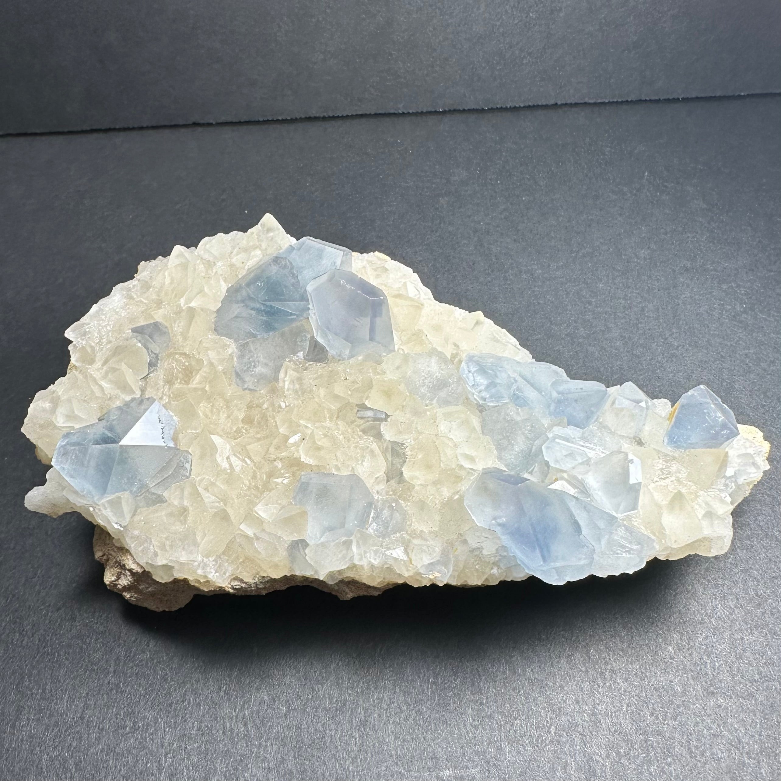 Celestite Crystals with Scalenohedral Calcite mineral specimen on matrix showing blue and creamy crystal formations