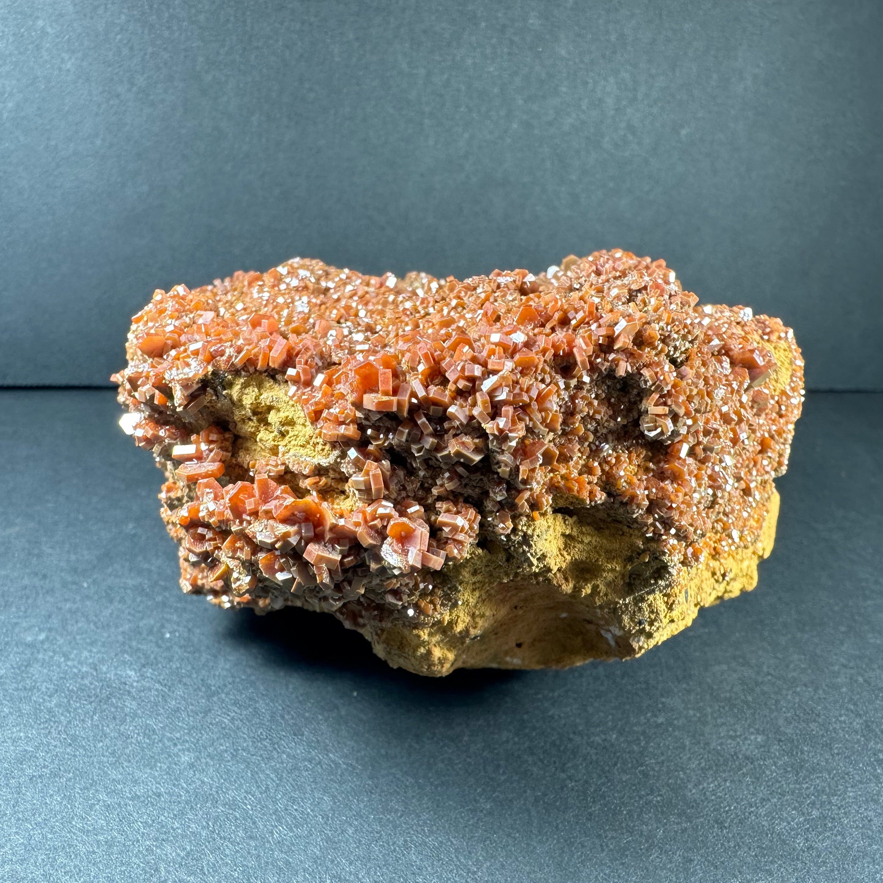 Vanadinite Crystals on Matrix from Morocco showing tabular brown crystals on light natural stone matrix