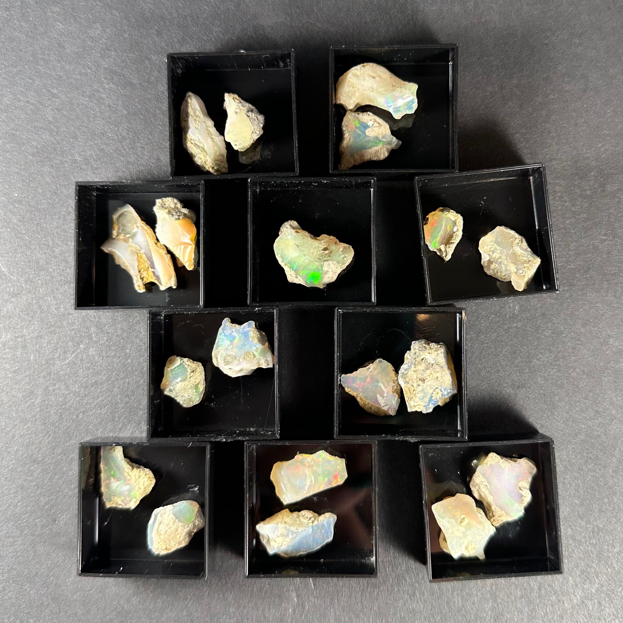 Welo Opal specimen from Ethiopia in a small square clear acrylic box.