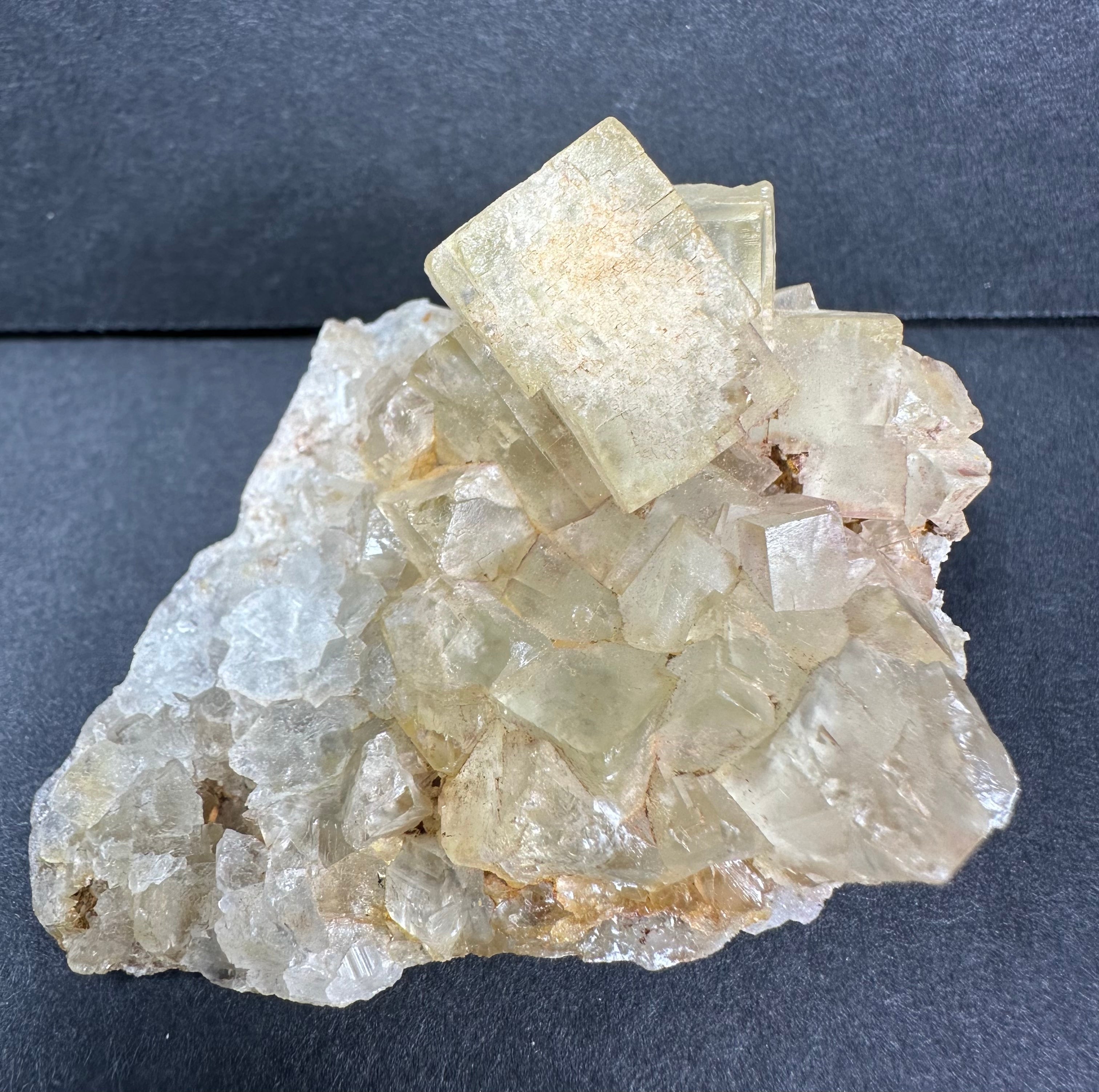 Yellow Cubic Fluorite crystal cluster showing geometric crystals with yellow tones