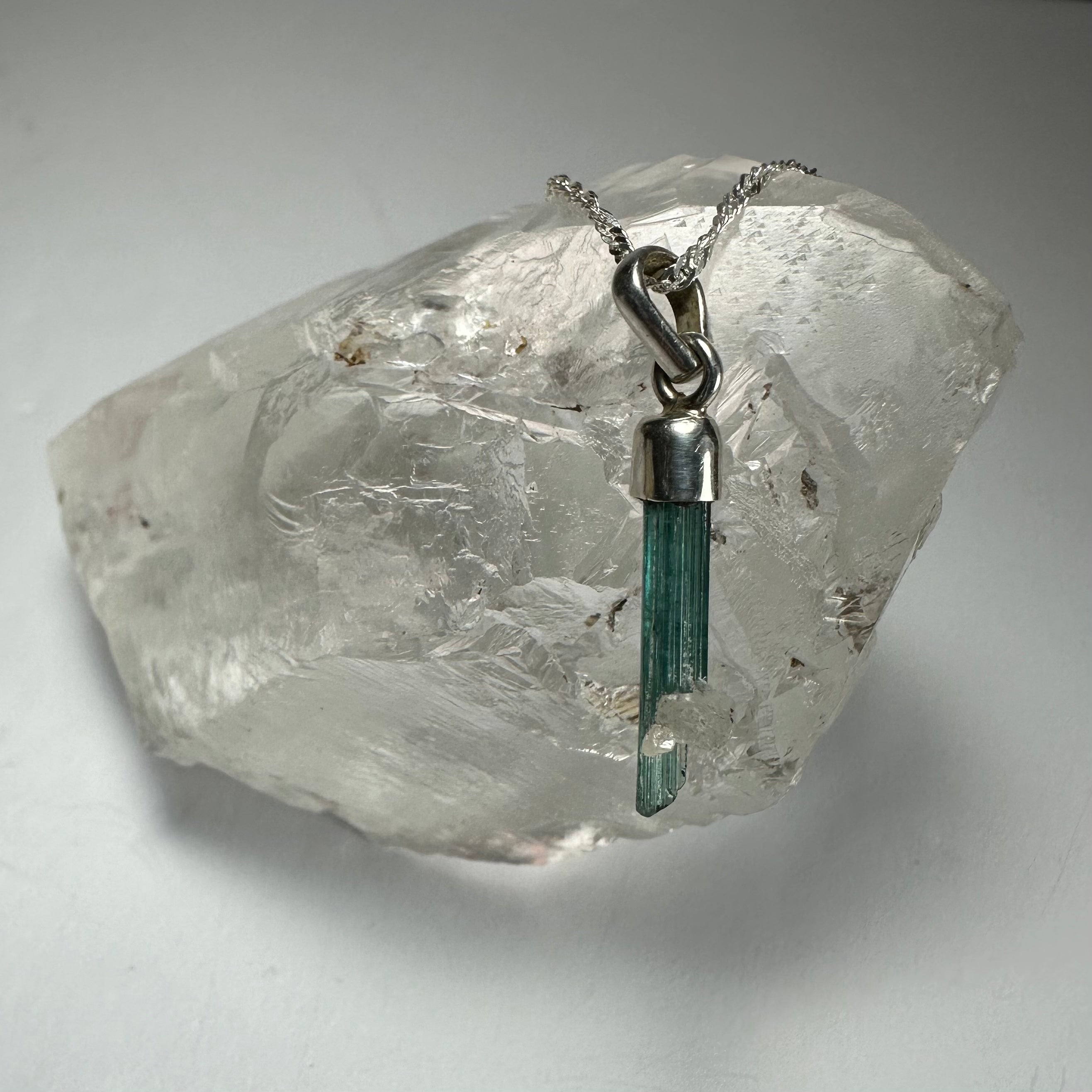 Natural Tourmaline Pencil Pendant in sterling silver setting with varied crystal coloration