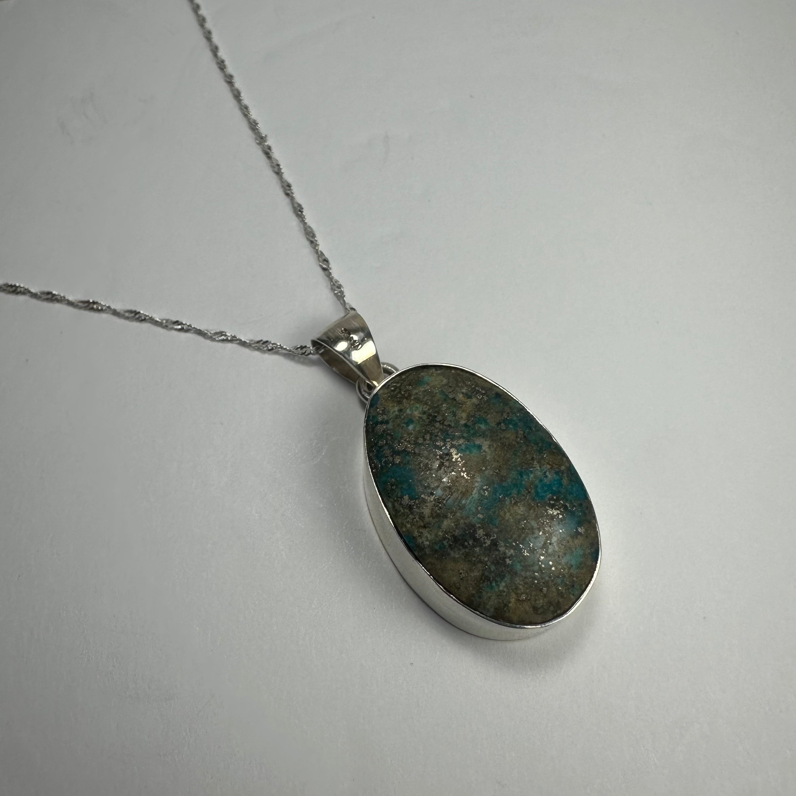Turquoise Pendant featuring a vibrant blue stone set in sterling silver