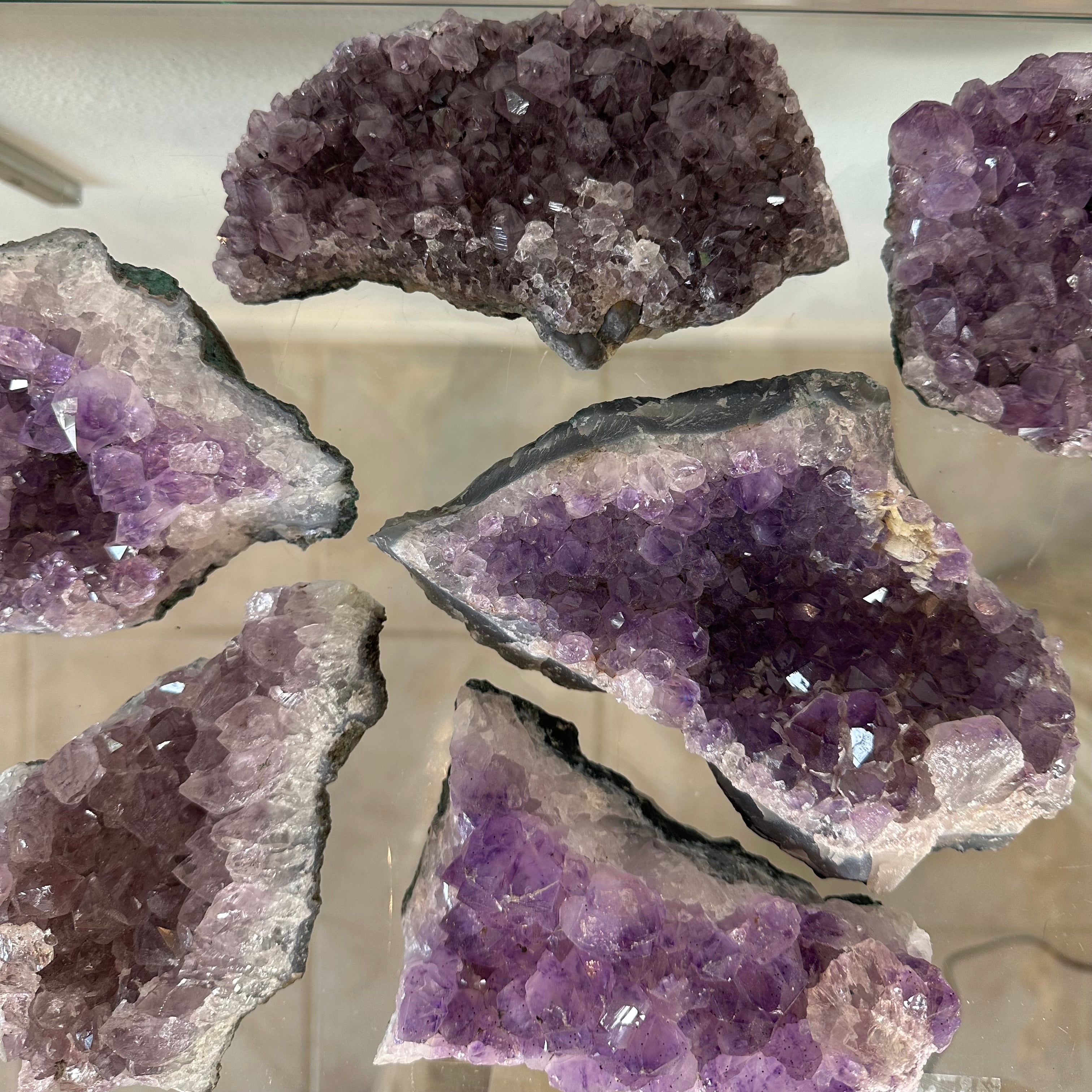 Medium Brazilian Amethyst Druze specimen showing sparkling purple crystal clusters within natural rocky matrix