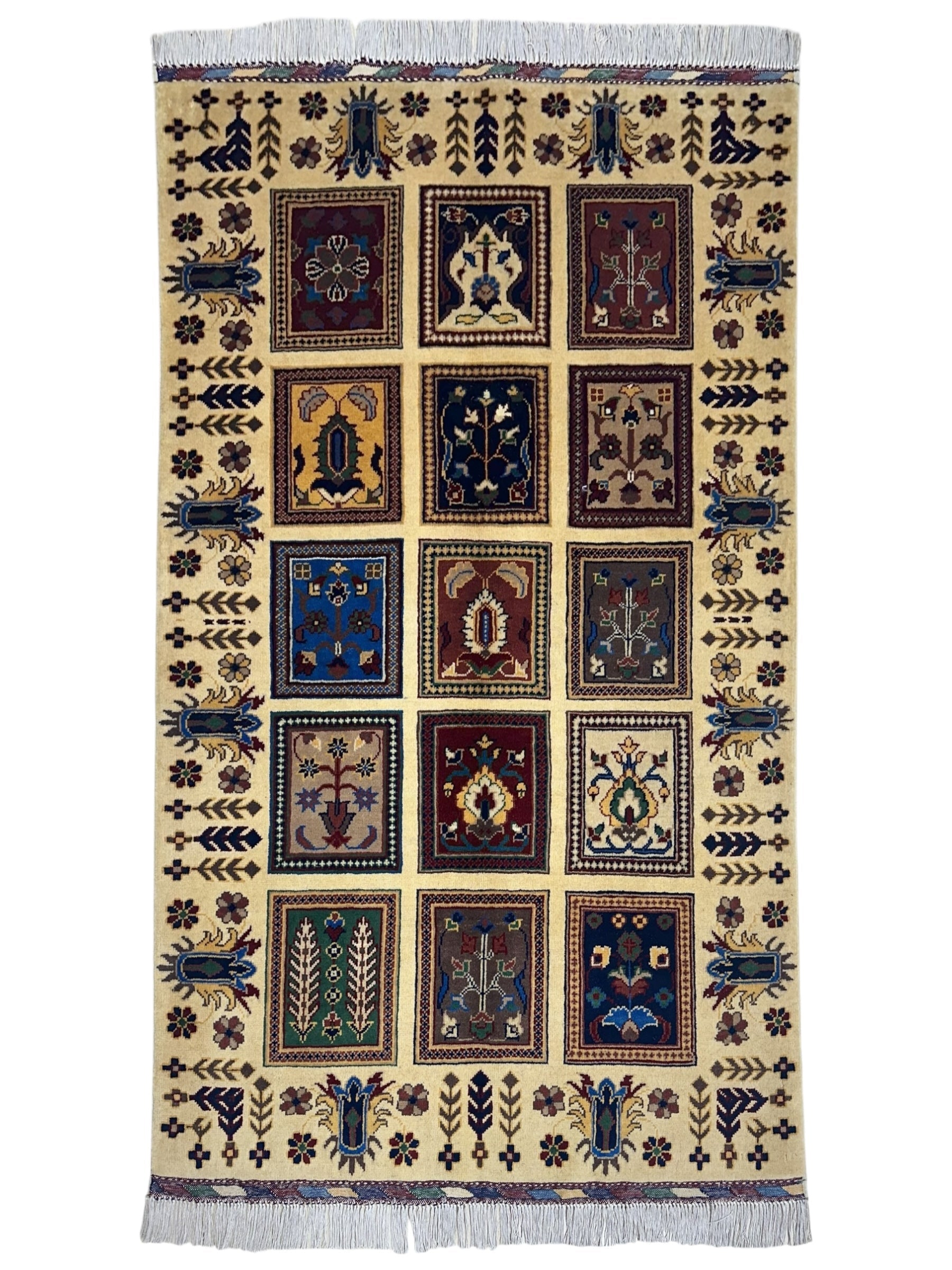 Hand-knotted Afghani Bakhteiari cream wool rug laid on wood flooring