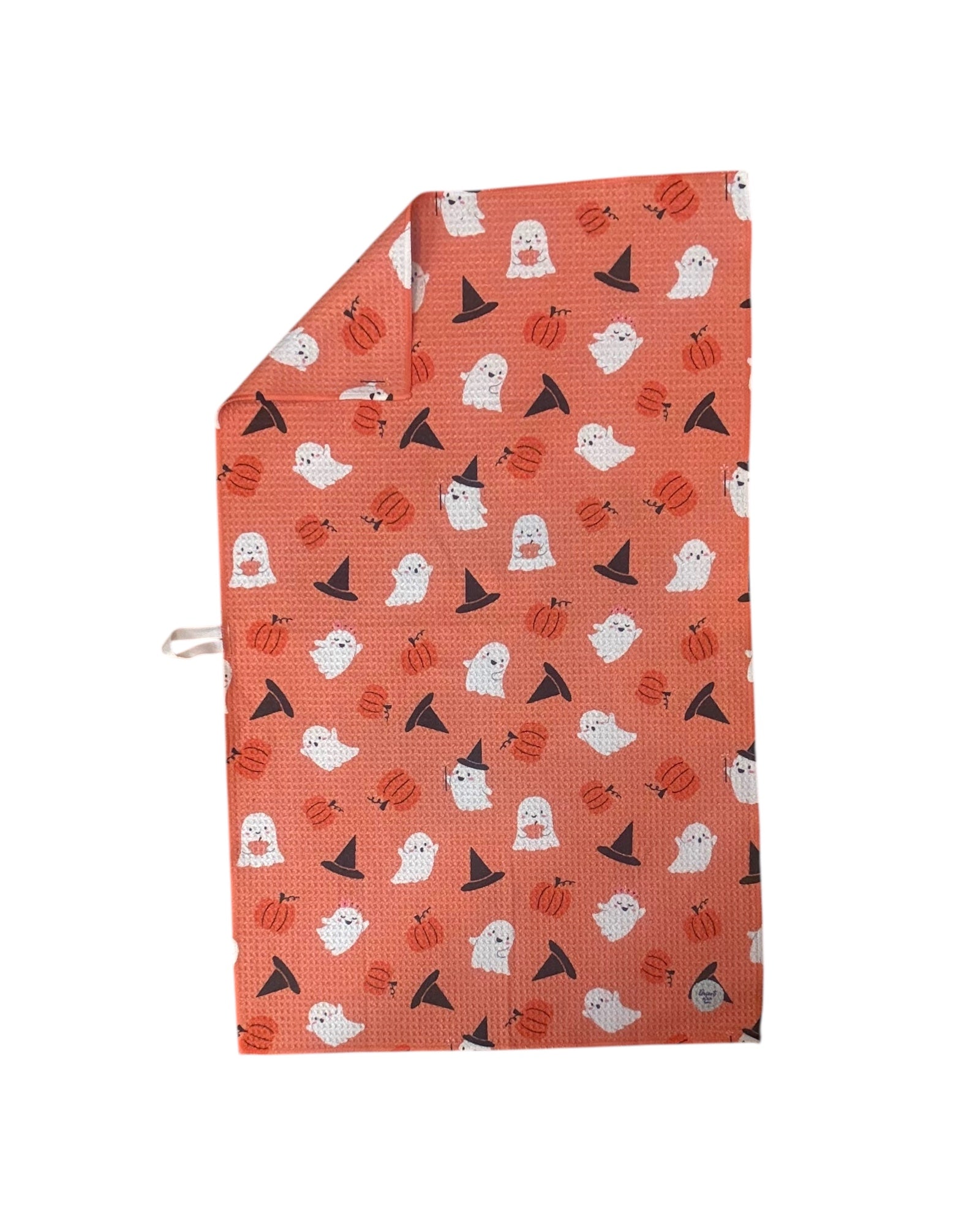 TRICK OR TREAT kitchen towel with orange, black, and fall-themed print hanging in kitchen