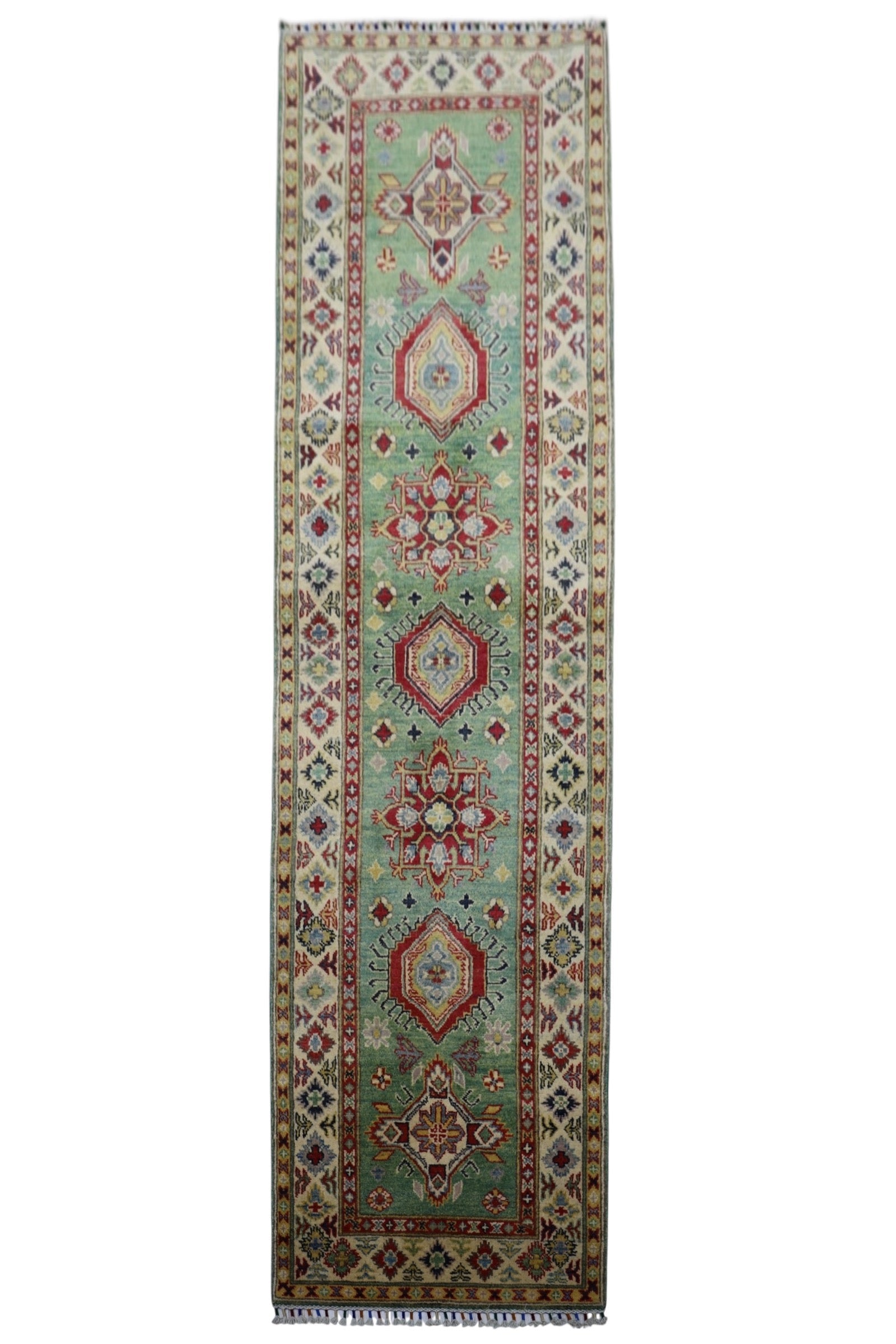 Hand-knotted Afghani Kazak wool rug featuring pistachio and red, sized 2’9″ x 9’2″, laid on floor