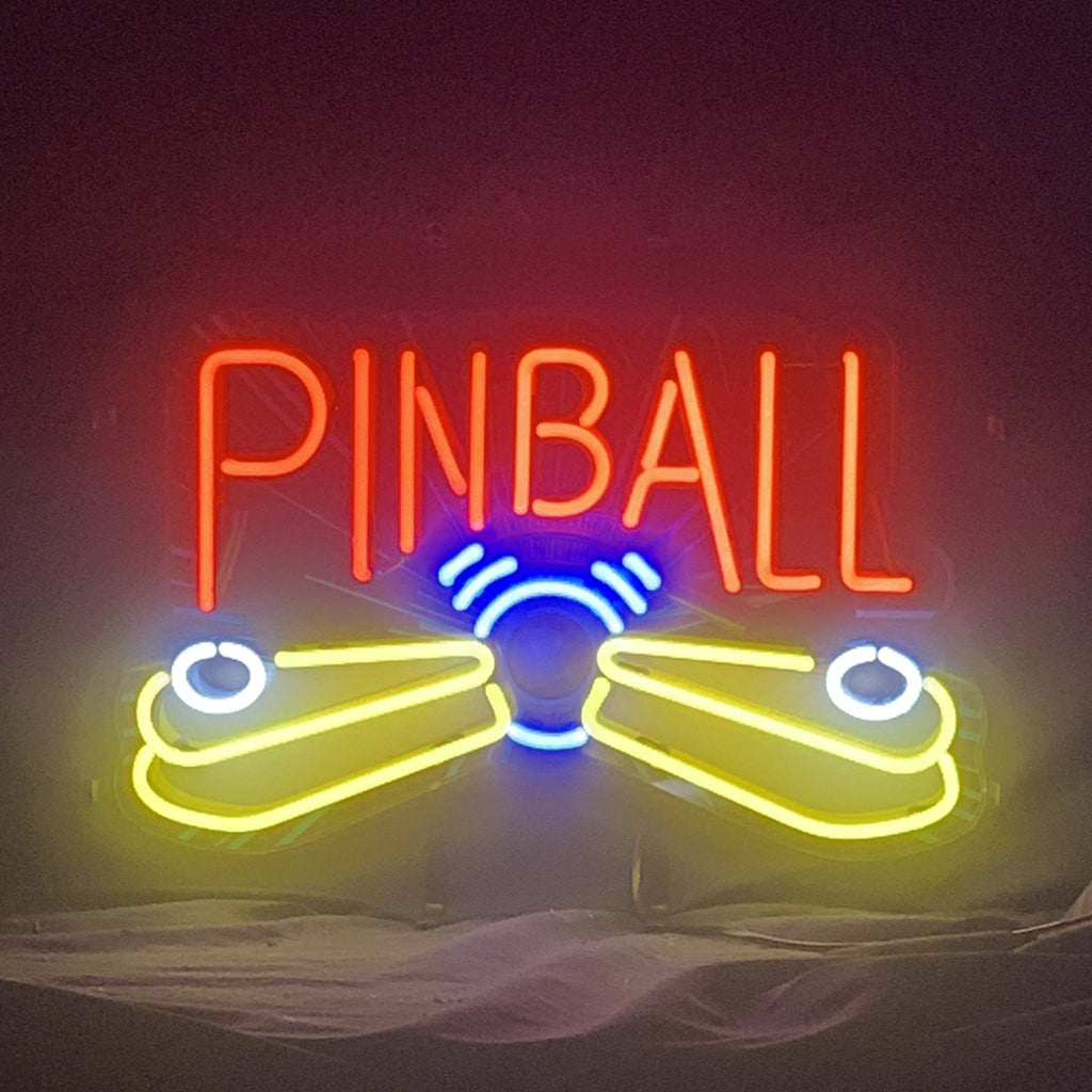 Pinball Game Machine Neon Sign lit against a dark background, showing vibrant neon colors and metal grid backing