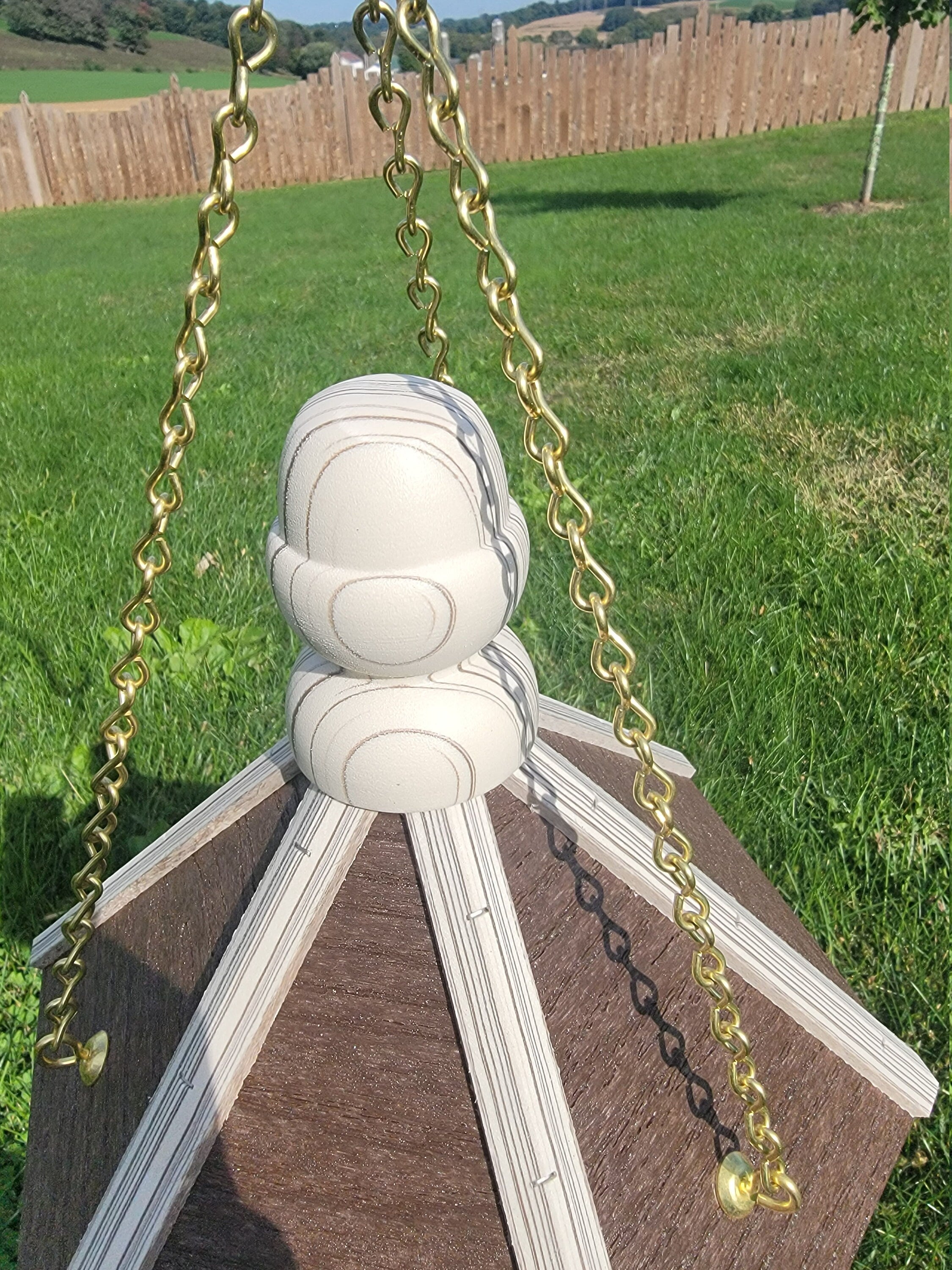 Amish handmade poly bird feeder with rustic spindle design, shown mounted outdoors