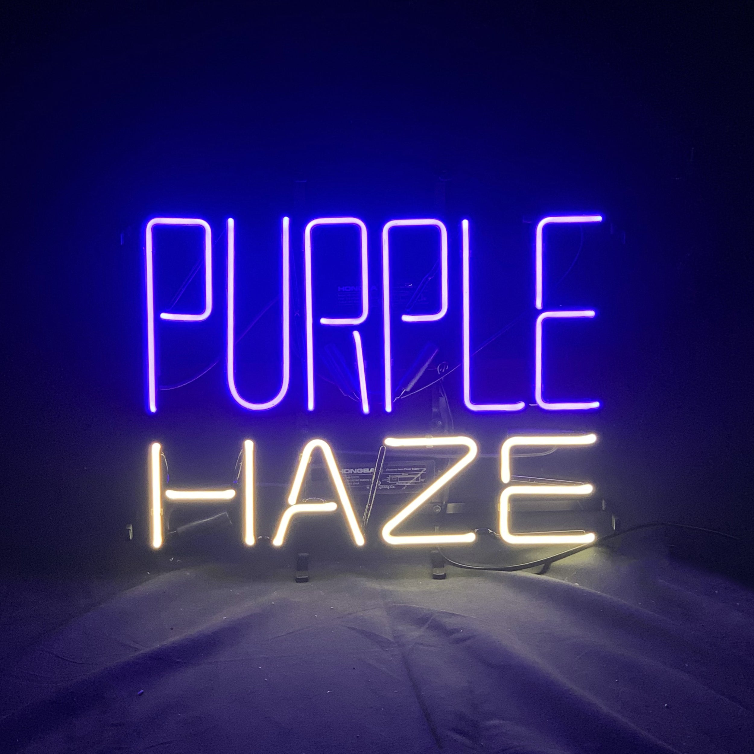 Purple Haze Beer Neon Sign Light glowing in purple on metal grid backing