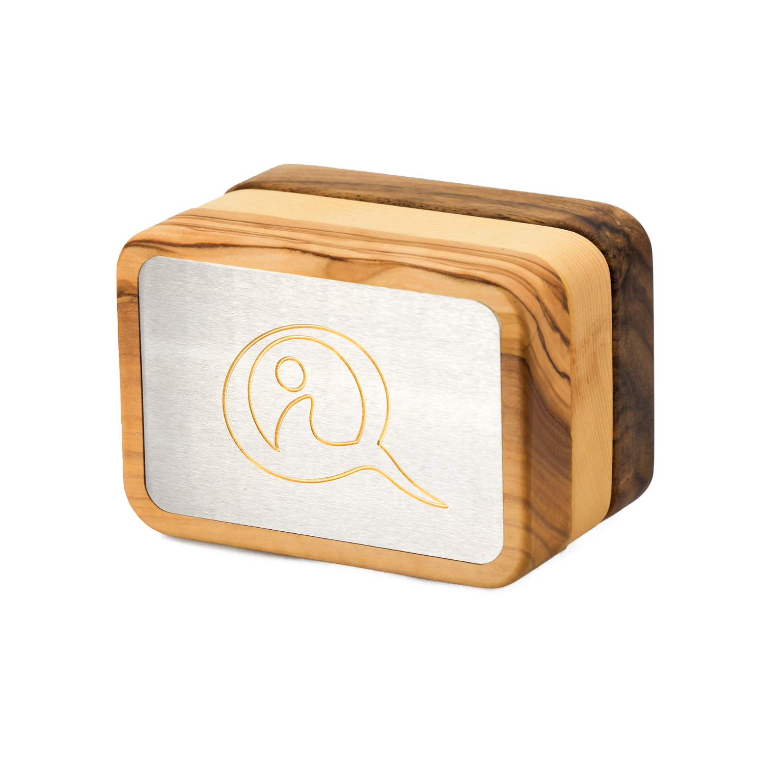 Three Qi-Me devices in Olive, Pine, and Walnut wood finishes displayed side by side on a white surface