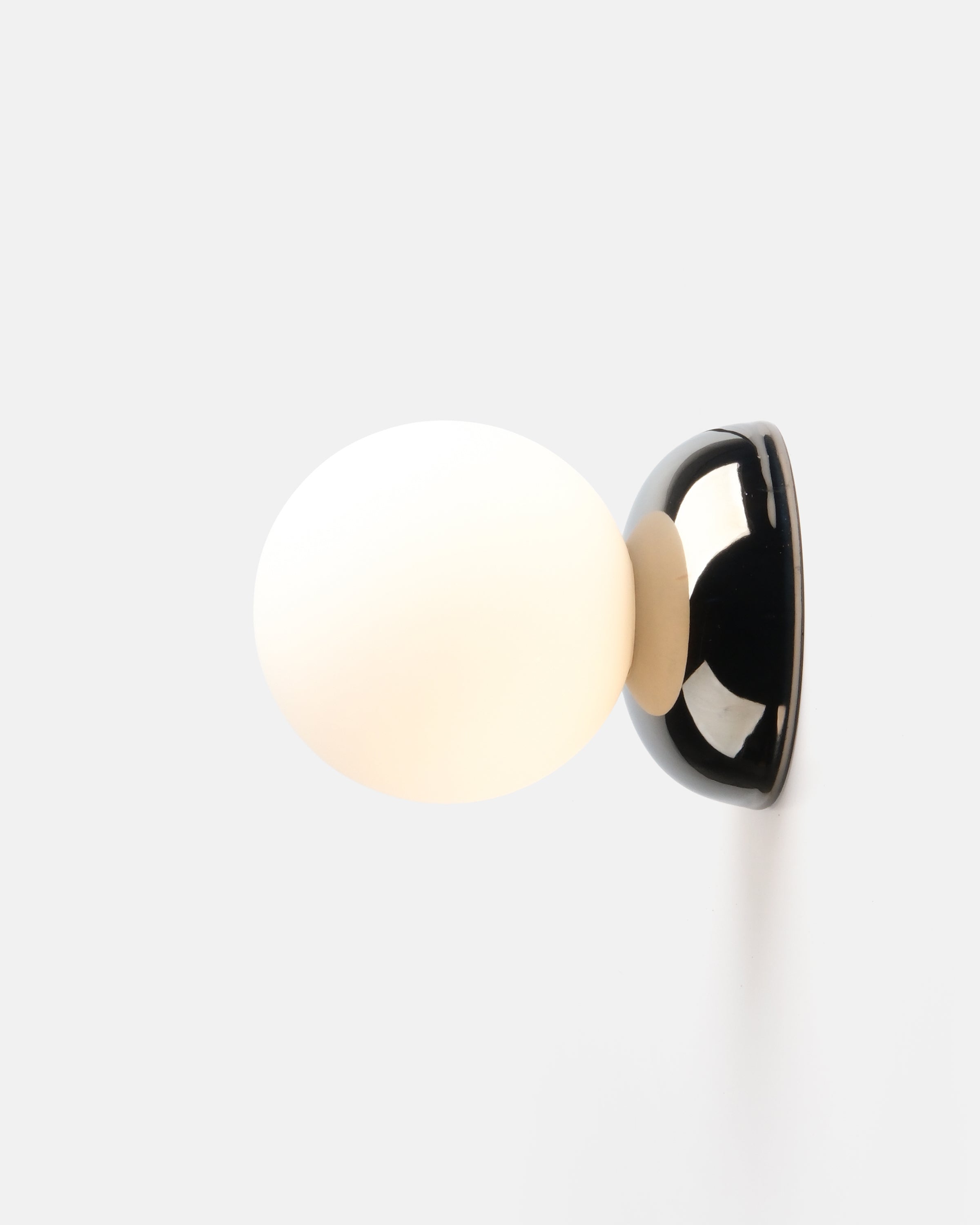 Ripple I Sconce by Misewell in chrome glaze mounted on a light wall