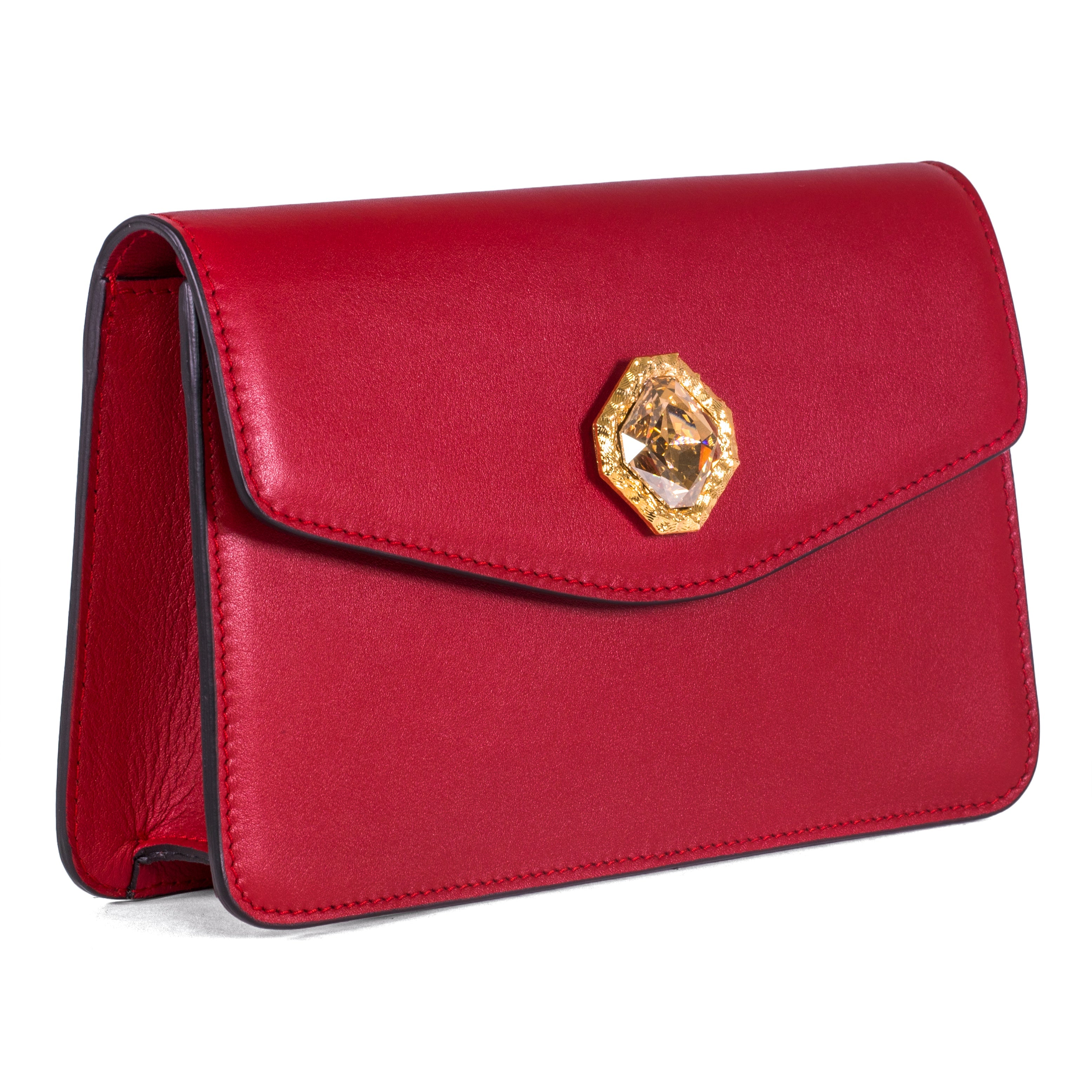 Red leather clutch bag with gold chain and central Swarovski crystal stone on a neutral background