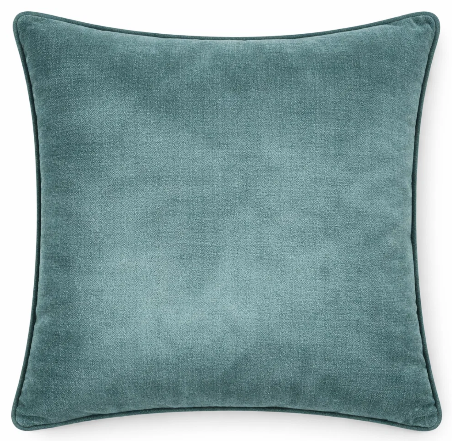 Montage Velvet Pillow Cover in rich teal shown on a sofa cushion.