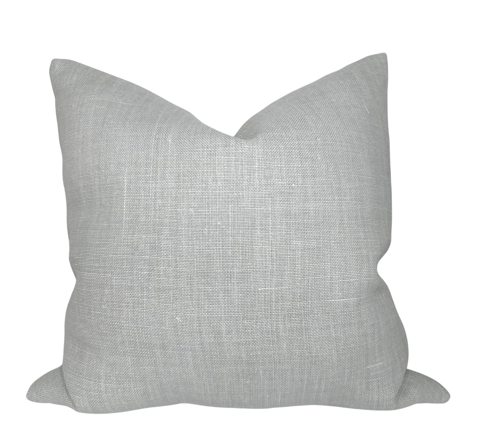 Mia Linen Pillow Cover in Pierre displayed on a couch with ivory linen backing visible