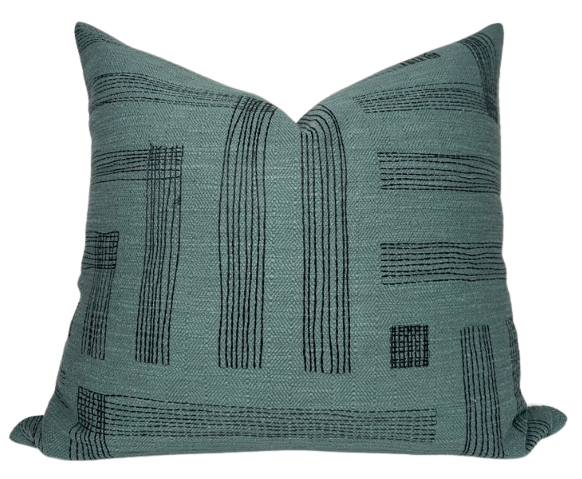 Pastiche Pillow Cover in Spruce Jet color displayed on a sofa setting