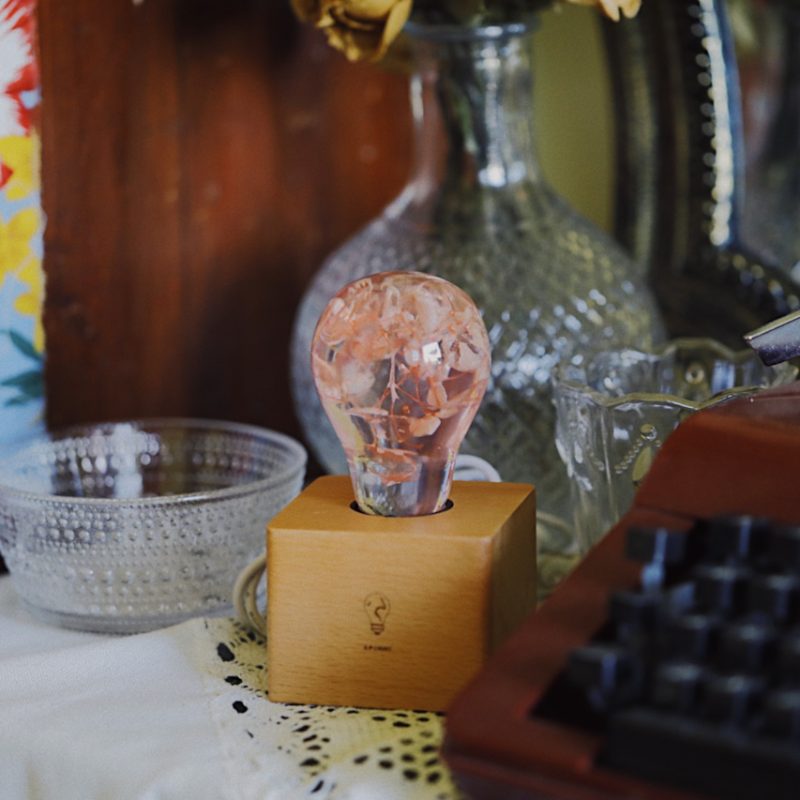 Three handcrafted flower-shaped resin LED bulbs in a 3-pack