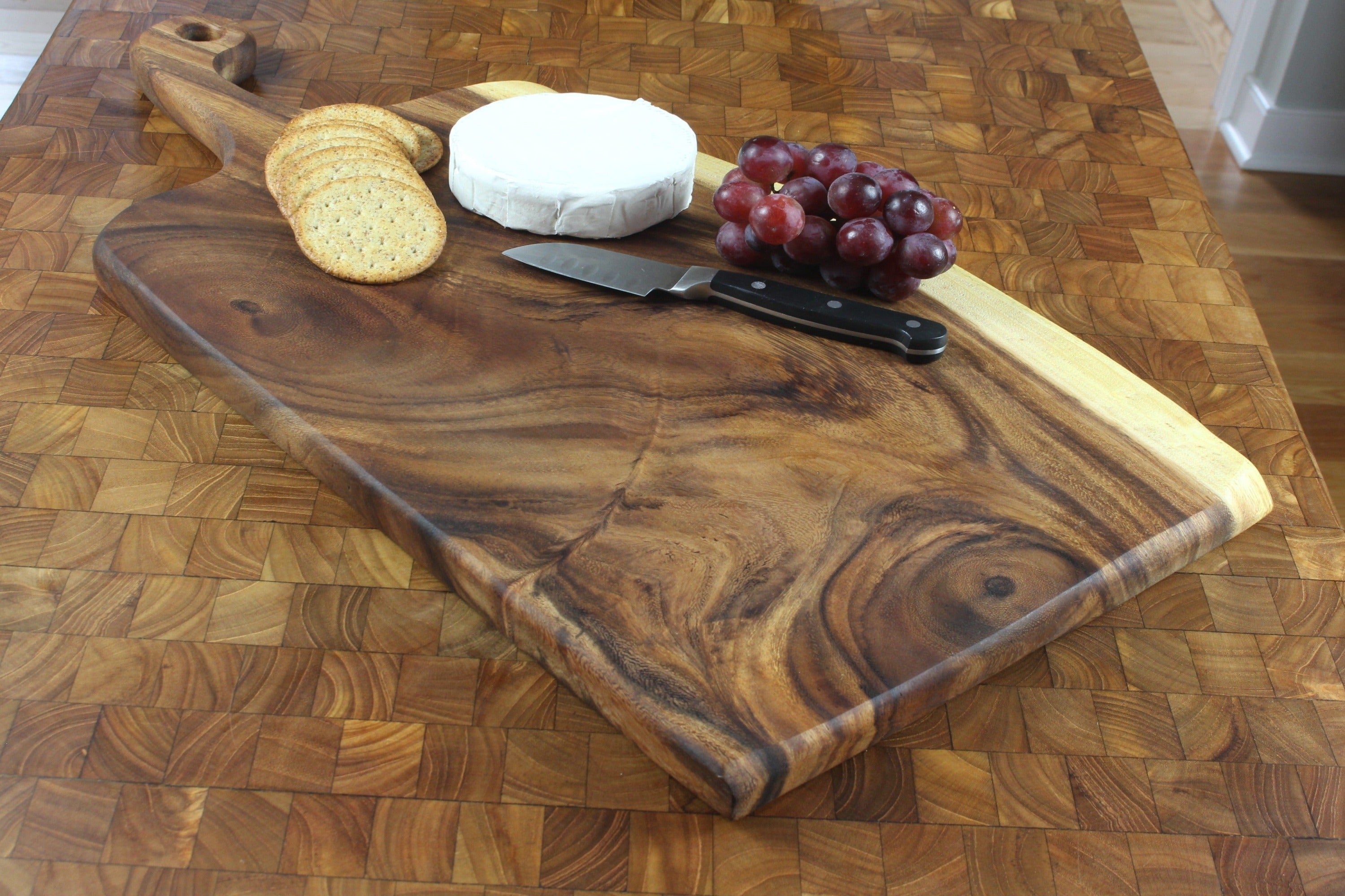 Extra Large Live Edge Handled Board made of East Indian Walnut with visible wood grain and live edges